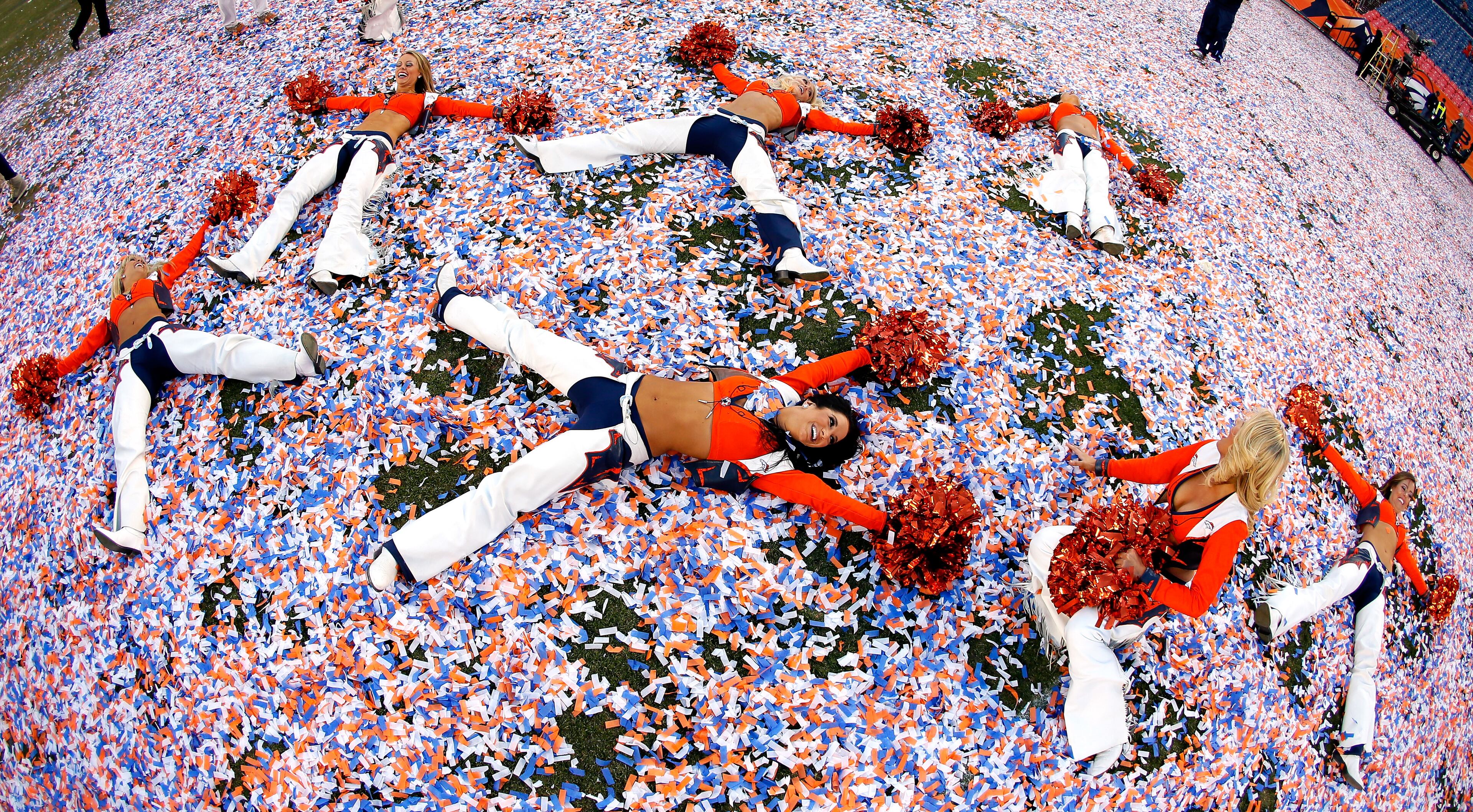 Denver Broncos cheerleaders celebrate after they defeated the New England Patriots 26 to 16 during the AFC Championship game at Sports Authority Field at Mile High on Jan. 19, 2014, in Denver, Colo.
