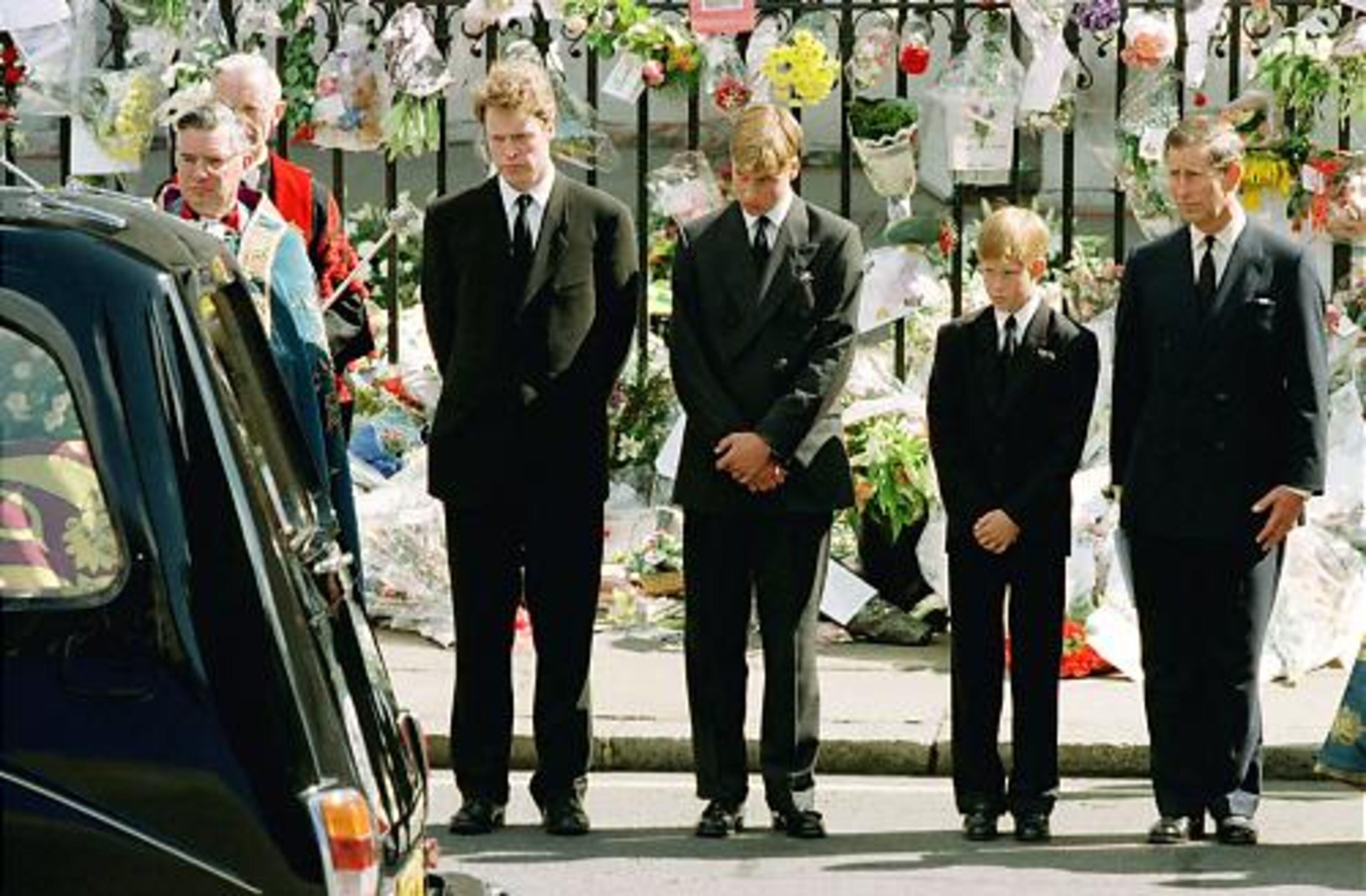 Prince Charles with his two sons, Prince Harry (second from right), and Prince William, along with Diana's brother Earl Spencer, watch the hearse bearing the coffin of Diana leave Westminster Abbey on Sept. 6, 1997.