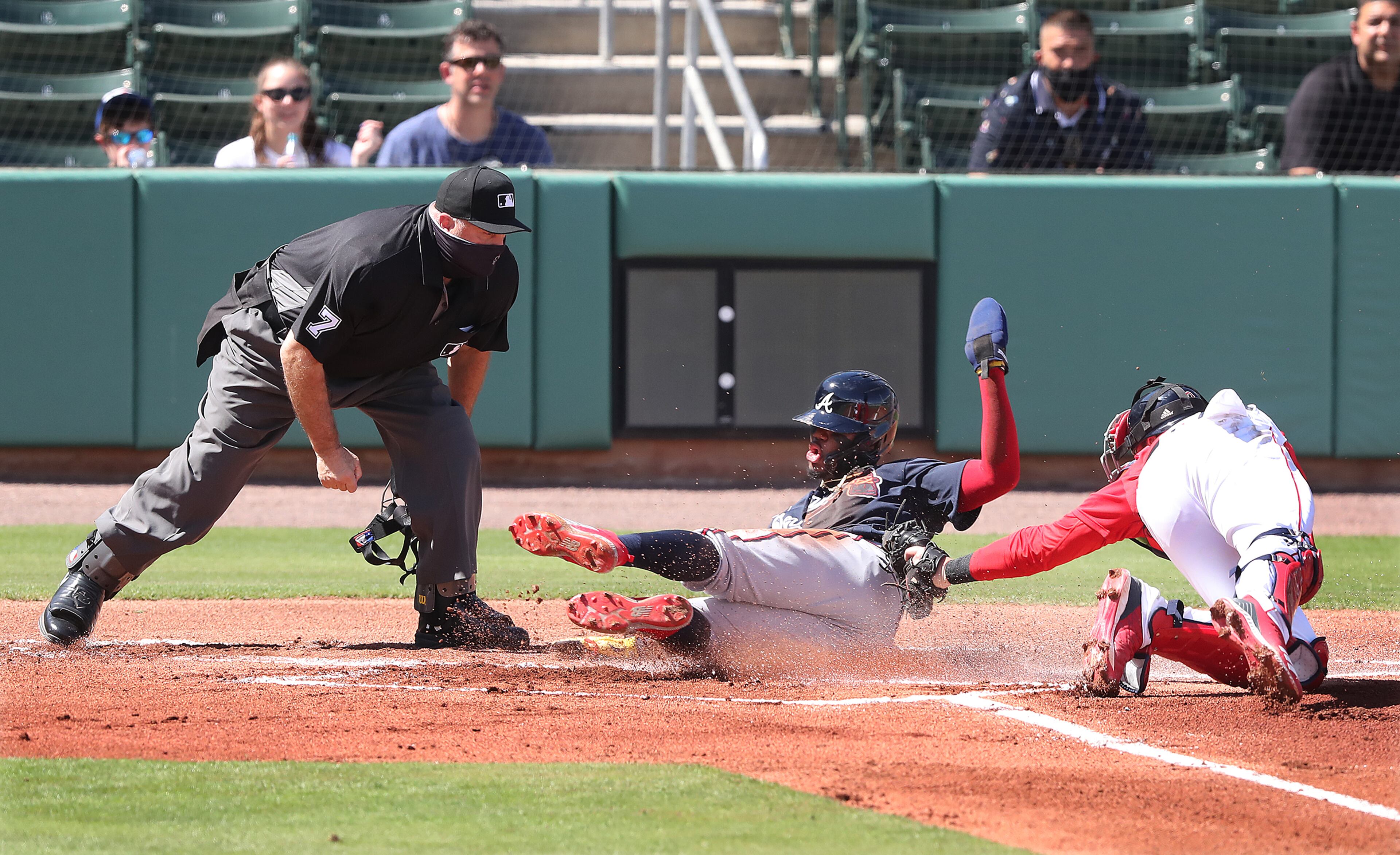 Atlanta Braves outfielder Ronald Acuna crosses home ahead of the tag by Boston Red Sox catcher Jett Bandy in the first inning Monday, March 1, 2021, at JetBlue Park in Fort Myers, Fla. Acuna scored on single by Jake Lamb. (Curtis Compton / Curtis.Compton@ajc.com)
