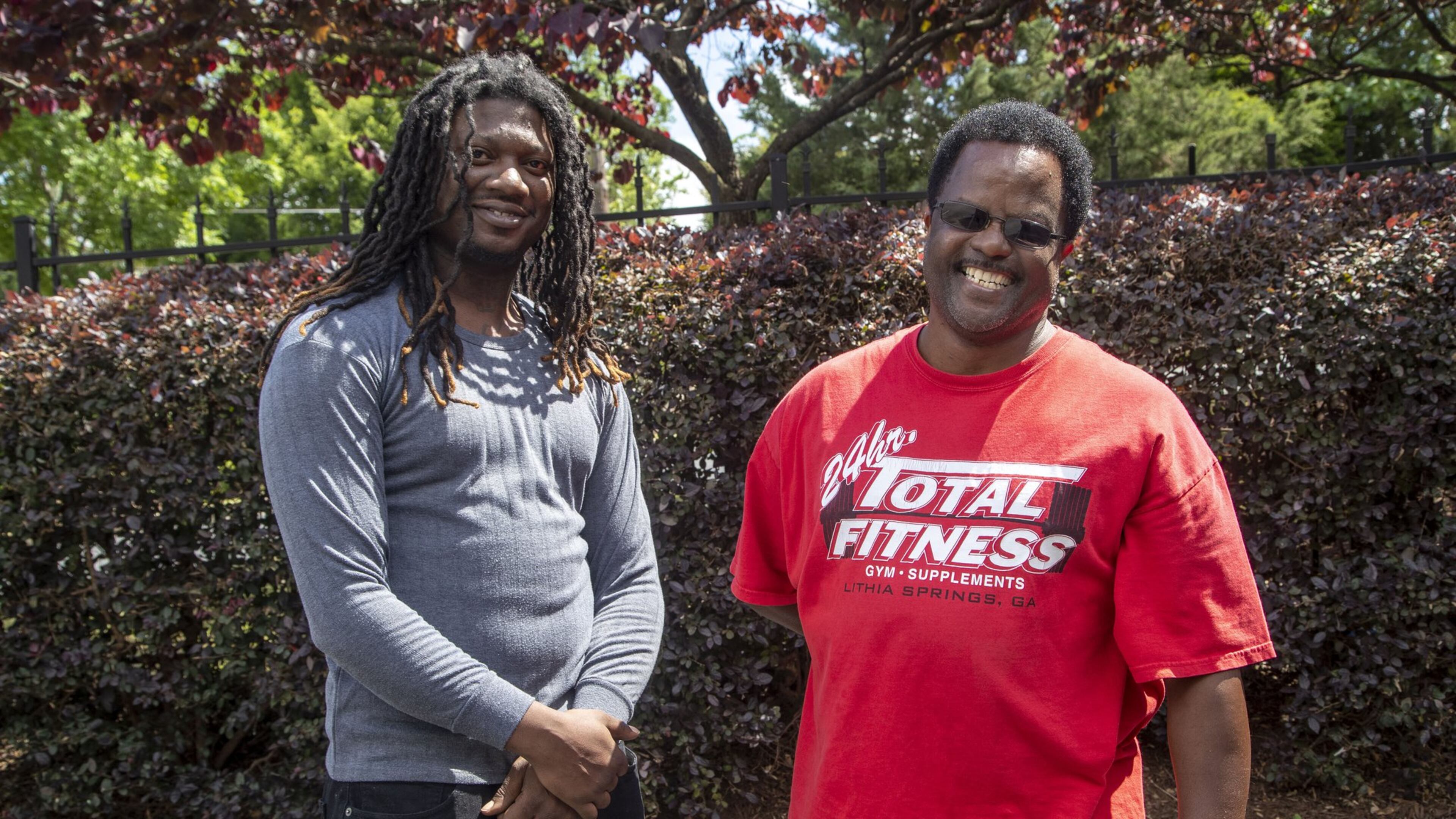 Alexander Harris (right) speaks with Johnny Eubanks outside of Harris’ residence in Atlanta’s Mechanicsville neighborhood. Harris has been a part of Eubanks’ life since Eubanks was 12. Eubanks says Harris taught him, among other things, how to be a family man and care for his children. ALYSSA POINTER / ALYSSA.POINTER@AJC.COM