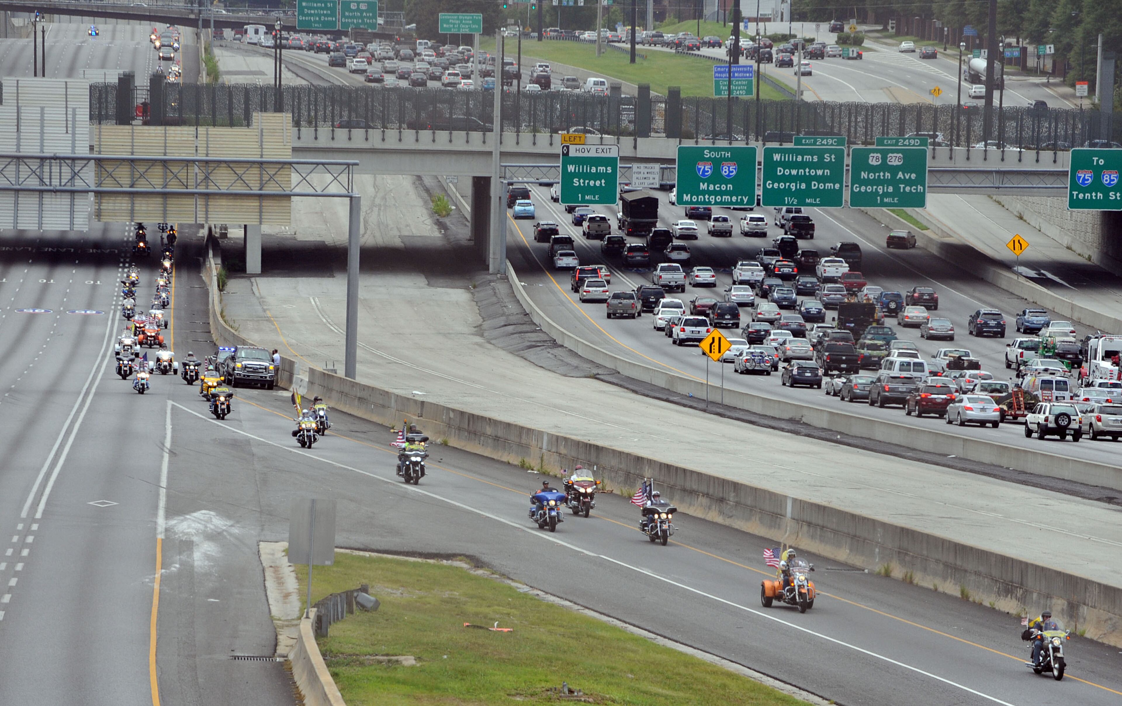A motorcade shuts down the Downtown Connector northbound as the body of Marine Corps Lance Cpl. Skip Wells was escorted from Hartsfield-Jackson International Airport Thursday, July 23, 2015. The Marietta Police Department shut down a portion of the Canton Road Connector Bridge over Interstate 75, so that the City and citizens could gather on the roadway to pay their respects to Lance Corporal Wells and the other Marines and Sailor who were killed in Chattanooga in the line of duty in a terrorist shooting last week. KENT D. JOHNSON /KDJOHNSON@AJC.COM