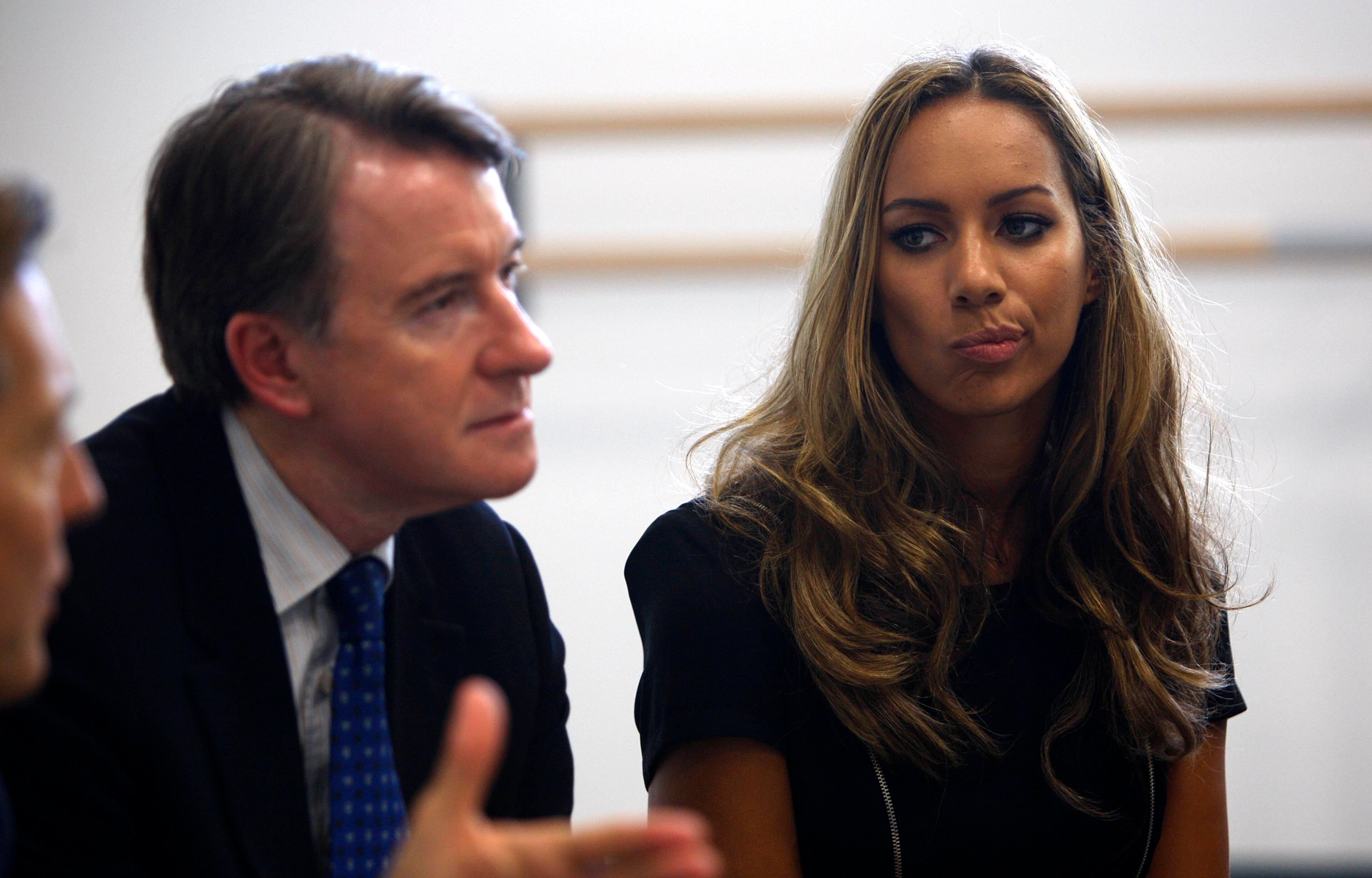 Business Secretary Peter Mandelson sits with pop singer Leona Lewis at the British school of performing arts Sept. 24, 2009, in Croydon, England.