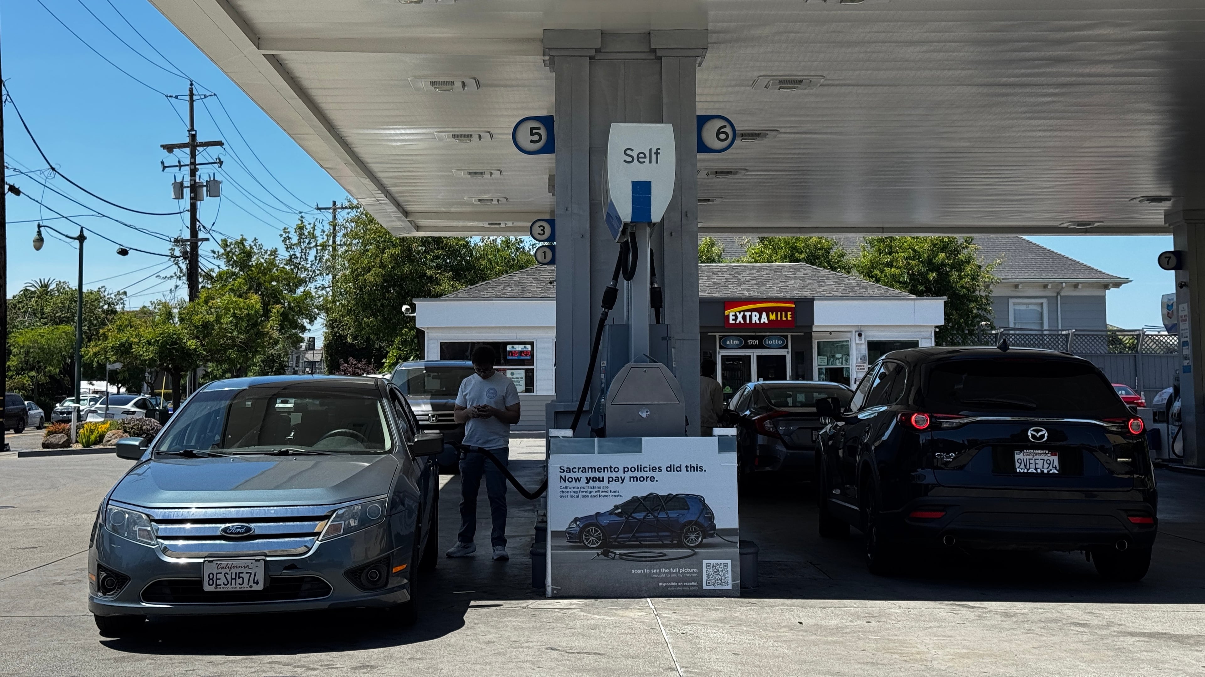 A sign blaming Sacramento policies for high gas prices is displayed at a Chevron gas station in Alameda, Calif., on Thursday, May 21, 2026. (AP Photo/Terry Chea)