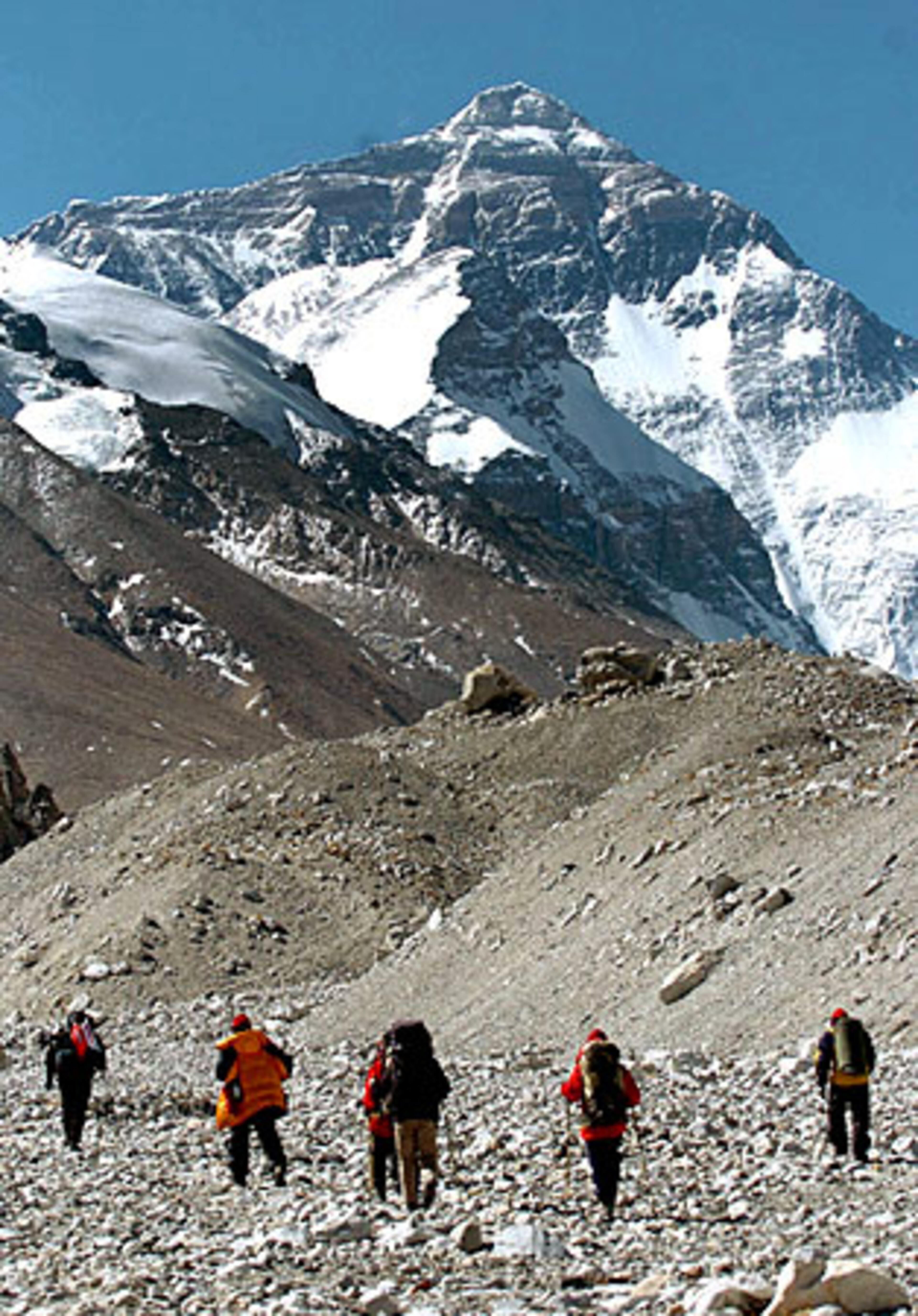 Members of the Chinese Mount Everest expedition team climb up to measure the height of the mountain.