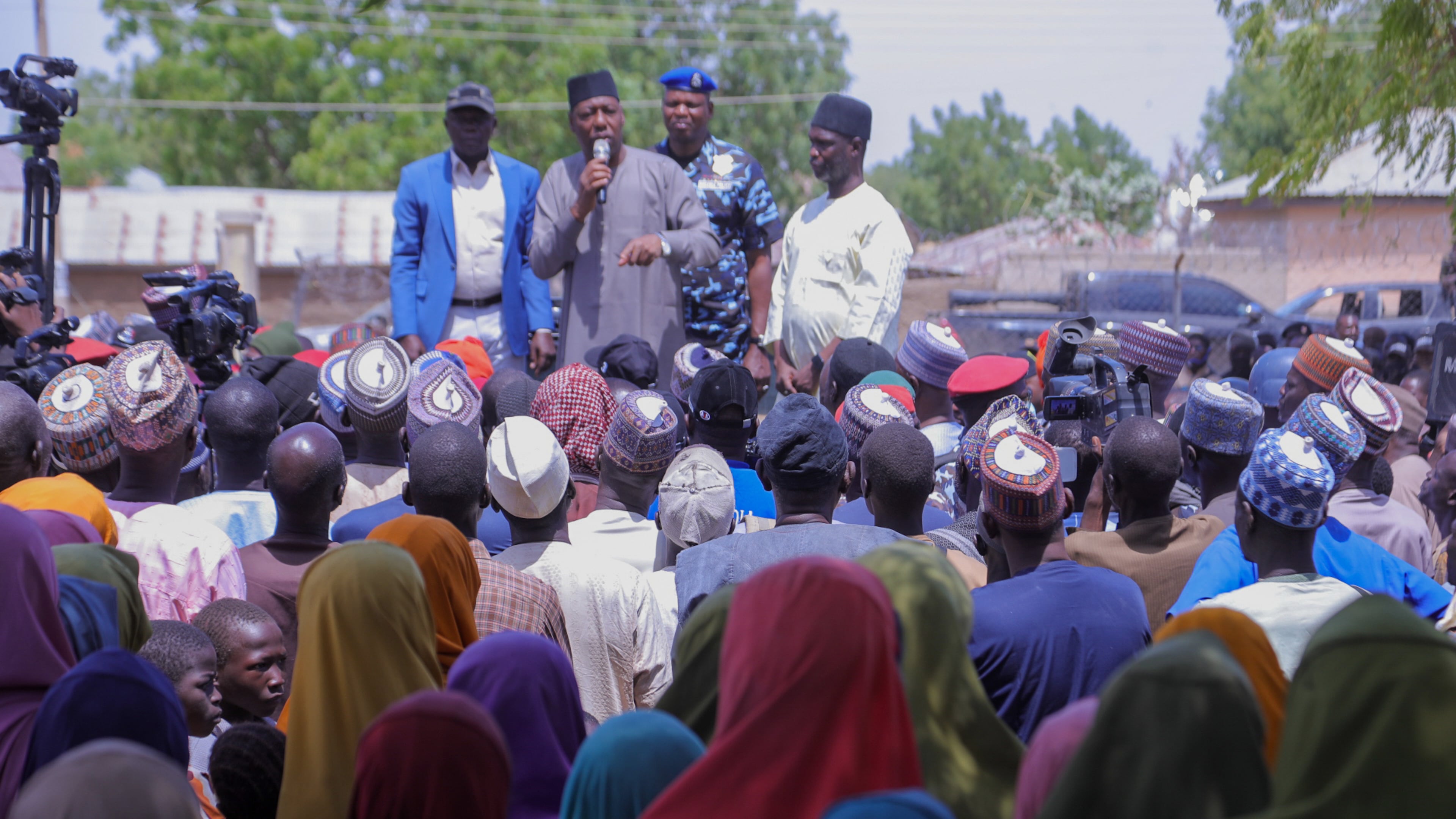 People listen to Babagana Zulum, the Borno state governor, in Pulka, Nigeria, Friday, March 6, 2026, after they fled an attack by Islamic militants in Ngoshe. (AP Photo/Jossy Ola)