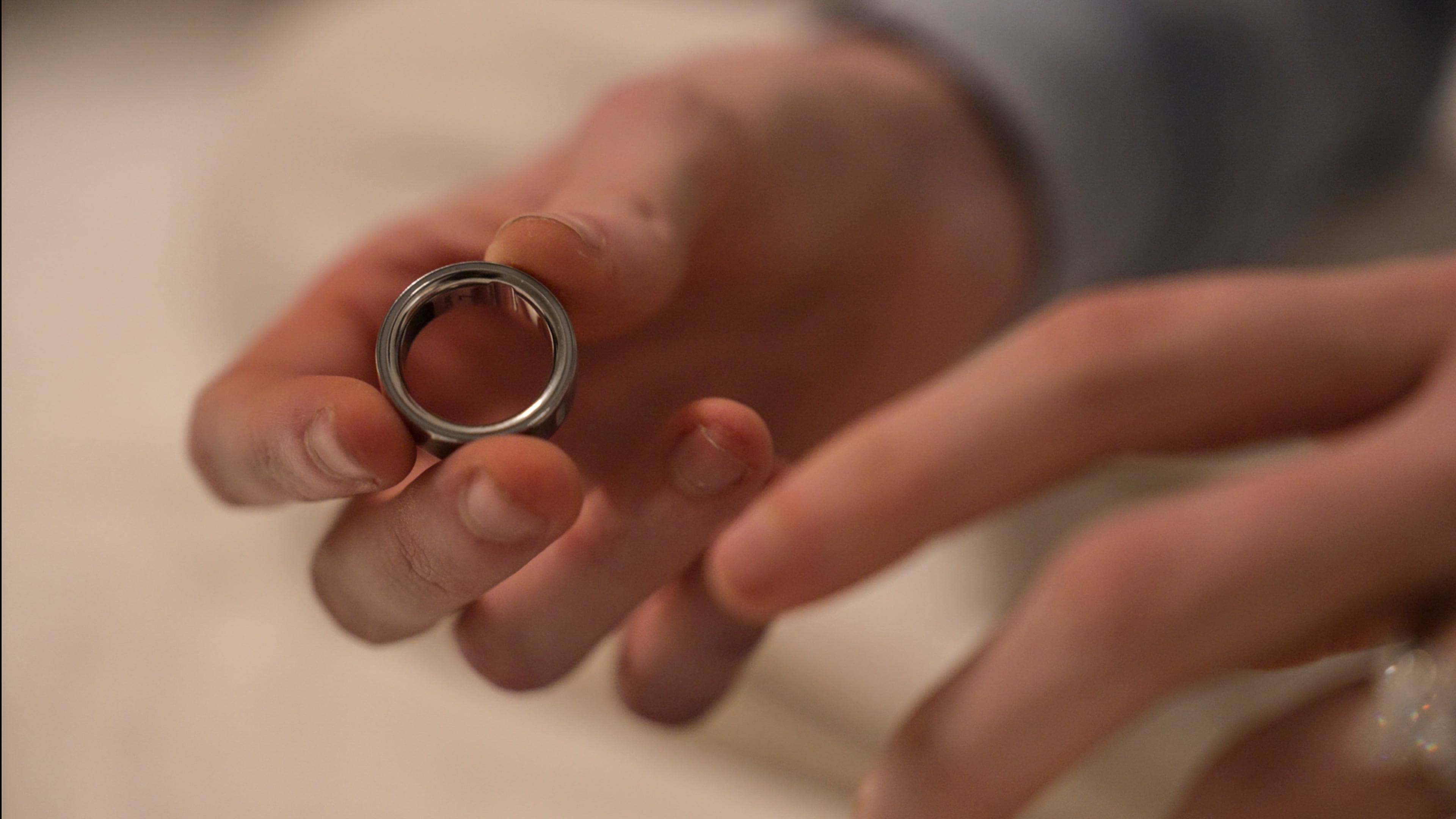 FILE - Middle school teacher Kate Stoye puts on an Oura ring, a wearable sleep tracking device, Wednesday, Jan. 7, 2026, in Hiram, Ga. (AP Photo/Emilie Megnien, file)