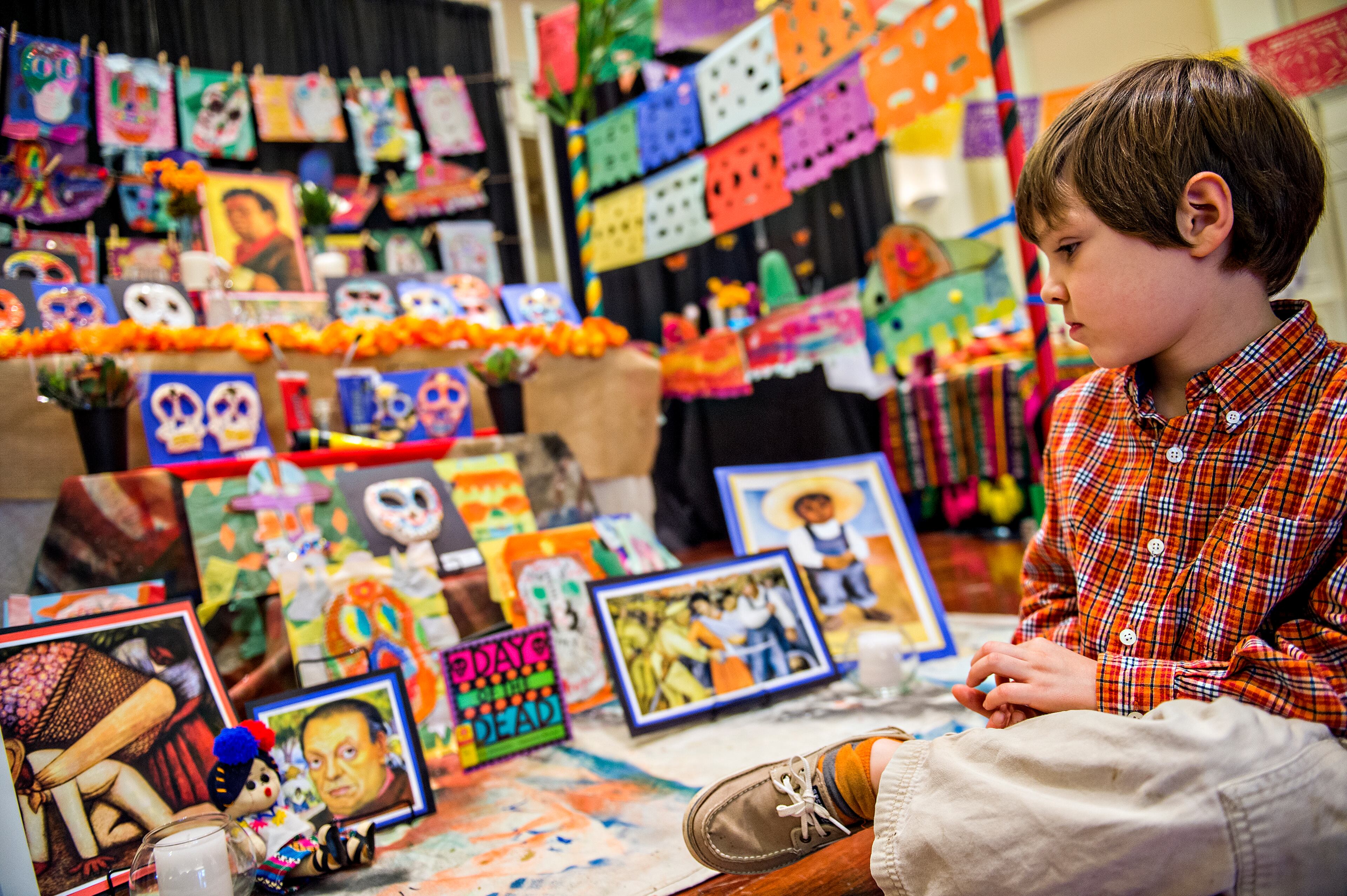 November 1, 2015 Atlanta - Ryan Wingfield sits in front of one of the dispalys during the Dia De Muertos, or Day of the Dead, Festival at the Atlanta History Center on Sunday, November 1, 2015. The festival featured storytelling, crafts, and authentic Mexican food and entertainment while teaching about the day that traditionally honors dead friends and loved ones. JONATHAN PHILLIPS / SPECIAL