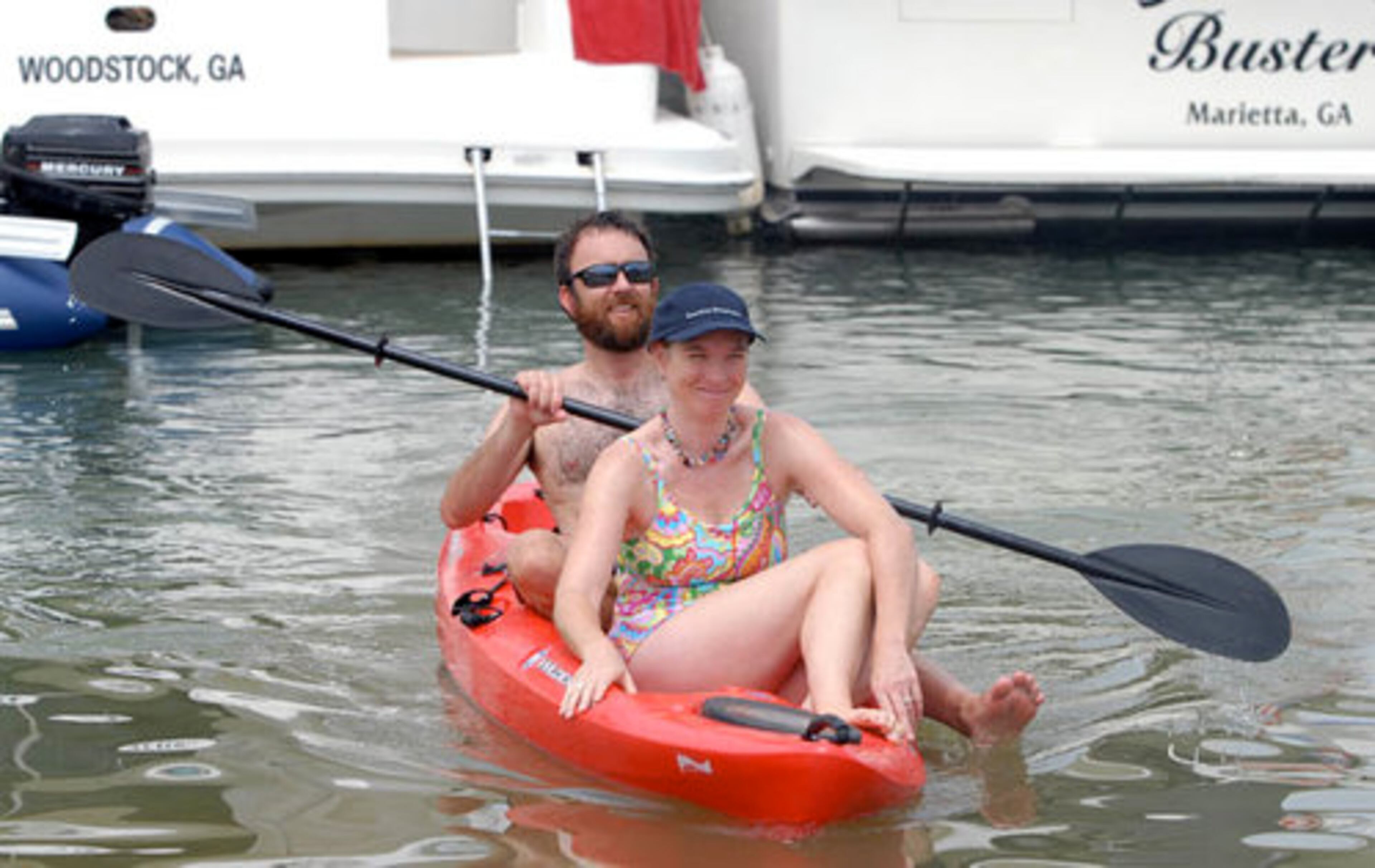 Tony and Tarn Eyl use a kayak to get from their docked boat to the beach.