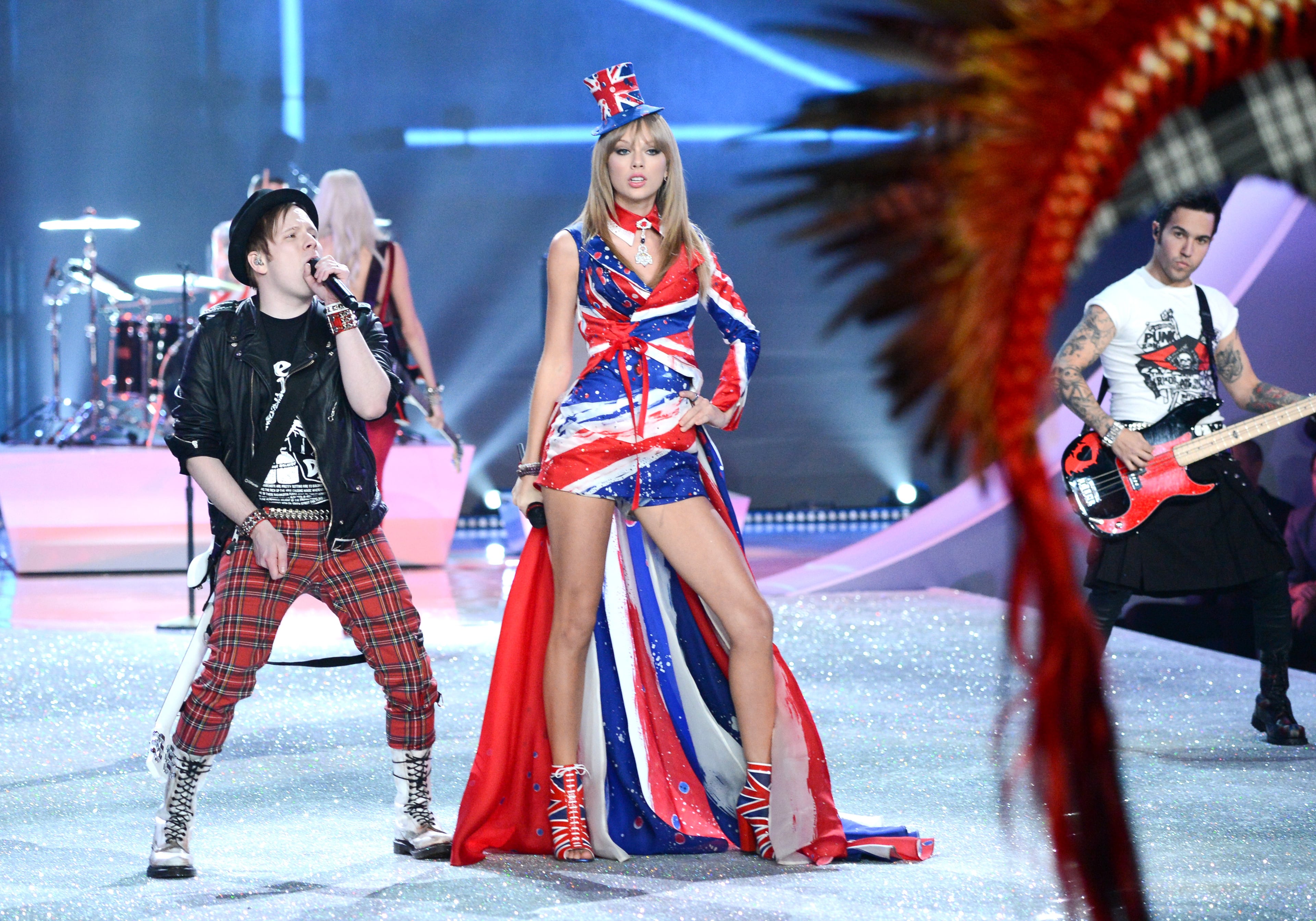 Singer Taylor Swift performs with Patrick Stump, left, and Pete Wentz of Fall Out Boy during the 2013 Victoria's Secret Fashion Show at the 69th Regiment Armory on Wednesday, Nov. 13, 2013 in New York. (Photo by Evan Agostini/Invision/AP)
