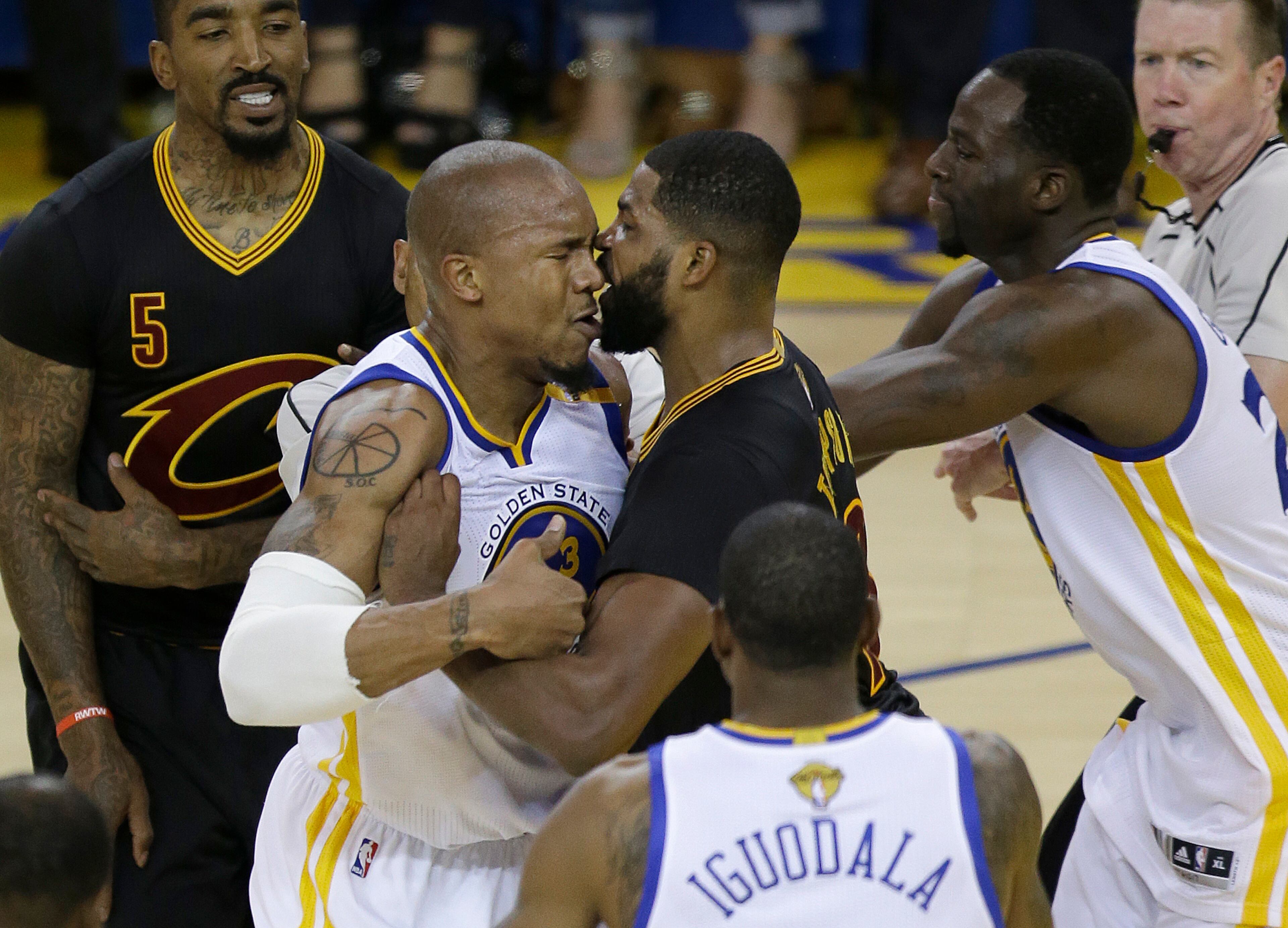 Cavaliers center Tristan Thompson (center right) confronts Golden State Warriors forward David West during the first half of Game 5 of basketball's NBA Finals.