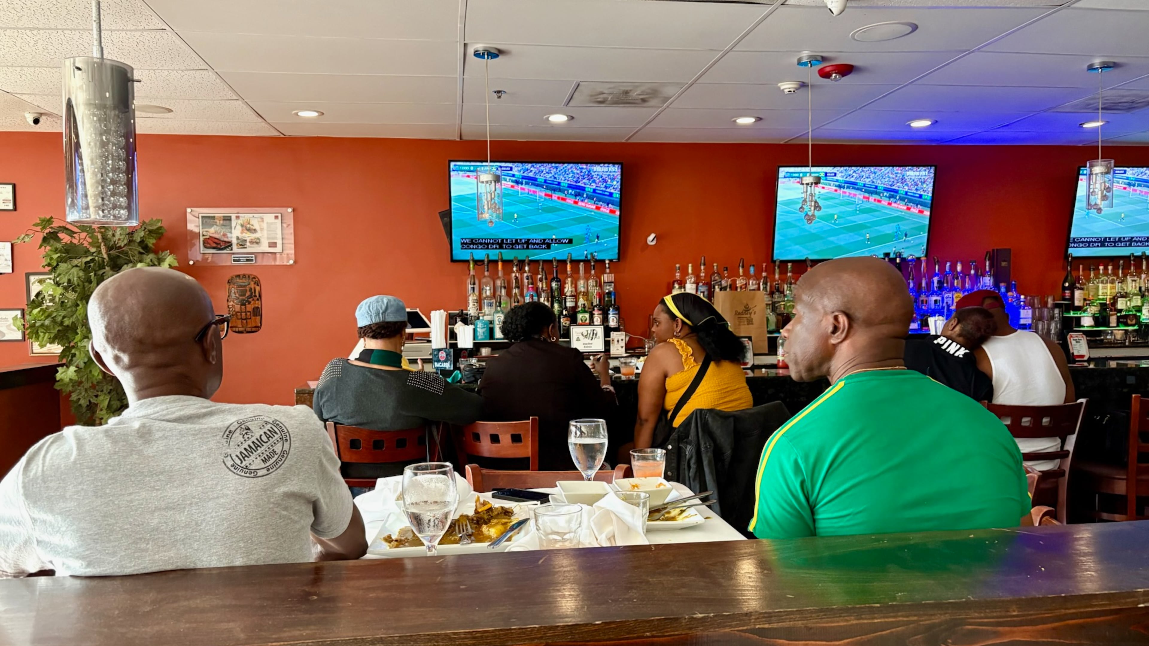 Jamaican Americans watch the Jamaica national soccer team in its World Cup qualifying match against the Democratic Republic of the Congo at Rodney's Jamaican Soul Food in Smyrna. (Ken Sugiura/AJC)