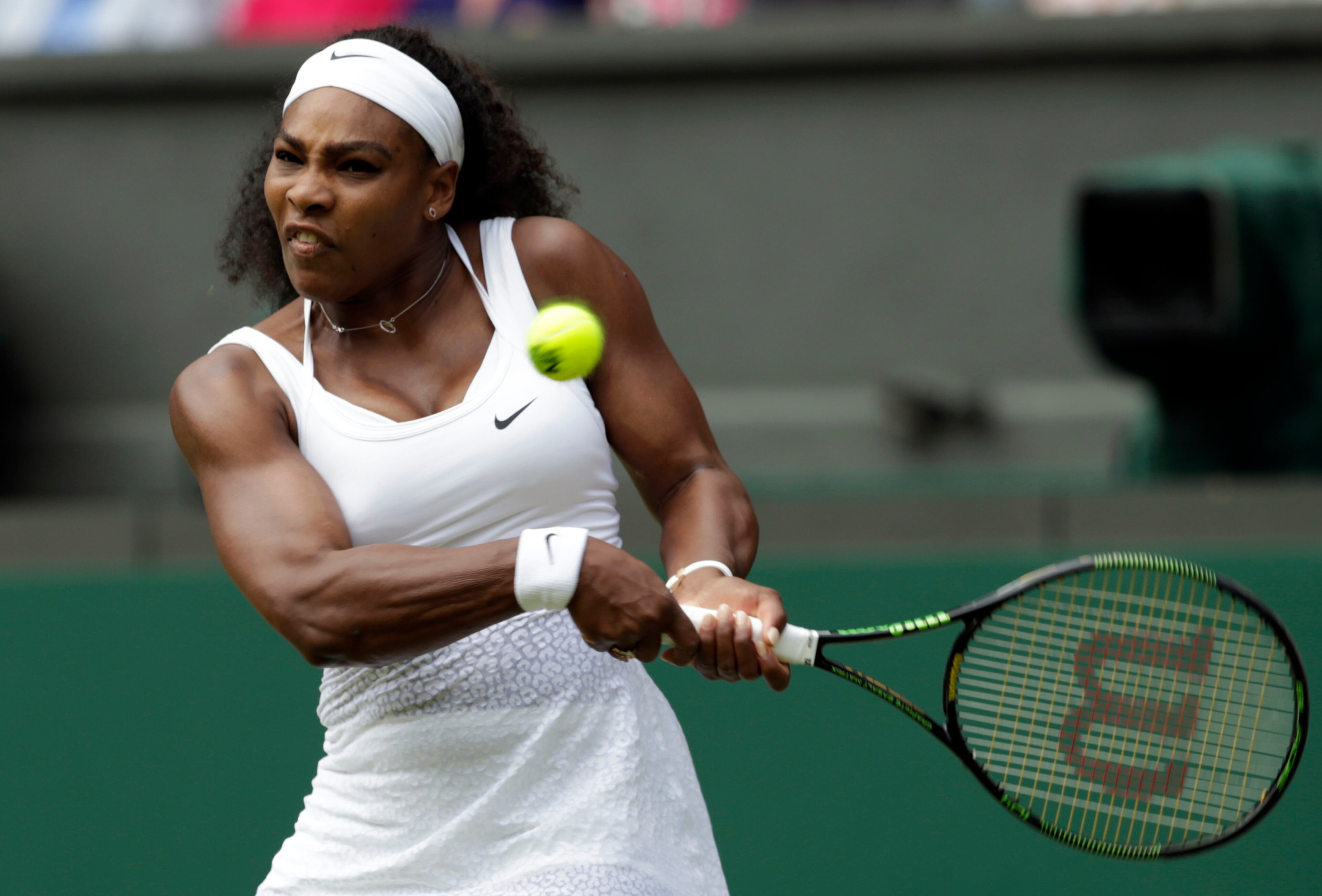 Serena Williams of the United States makes a return to Venus Williams of the United States, during their singles match against at the All England Lawn Tennis Championships in Wimbledon, London, Monday July 6, 2015. (AP Photo/Alastair Grant)
