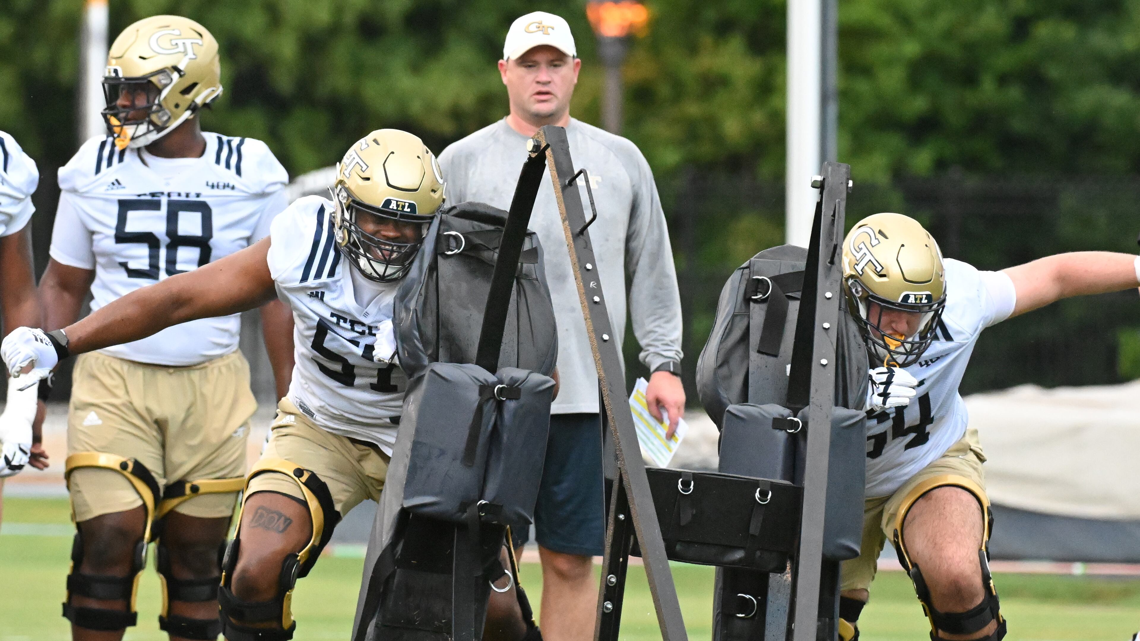Georgia Tech offensive linemen Paul Tchio (57) and Ryan Purves (64) work on their drills during the first football practice of the season at Rose Bowl Field on Georgia Tech Campus in Atlanta on Friday, August 5, 2022. (Hyosub Shin / Hyosub.Shin@ajc.com)