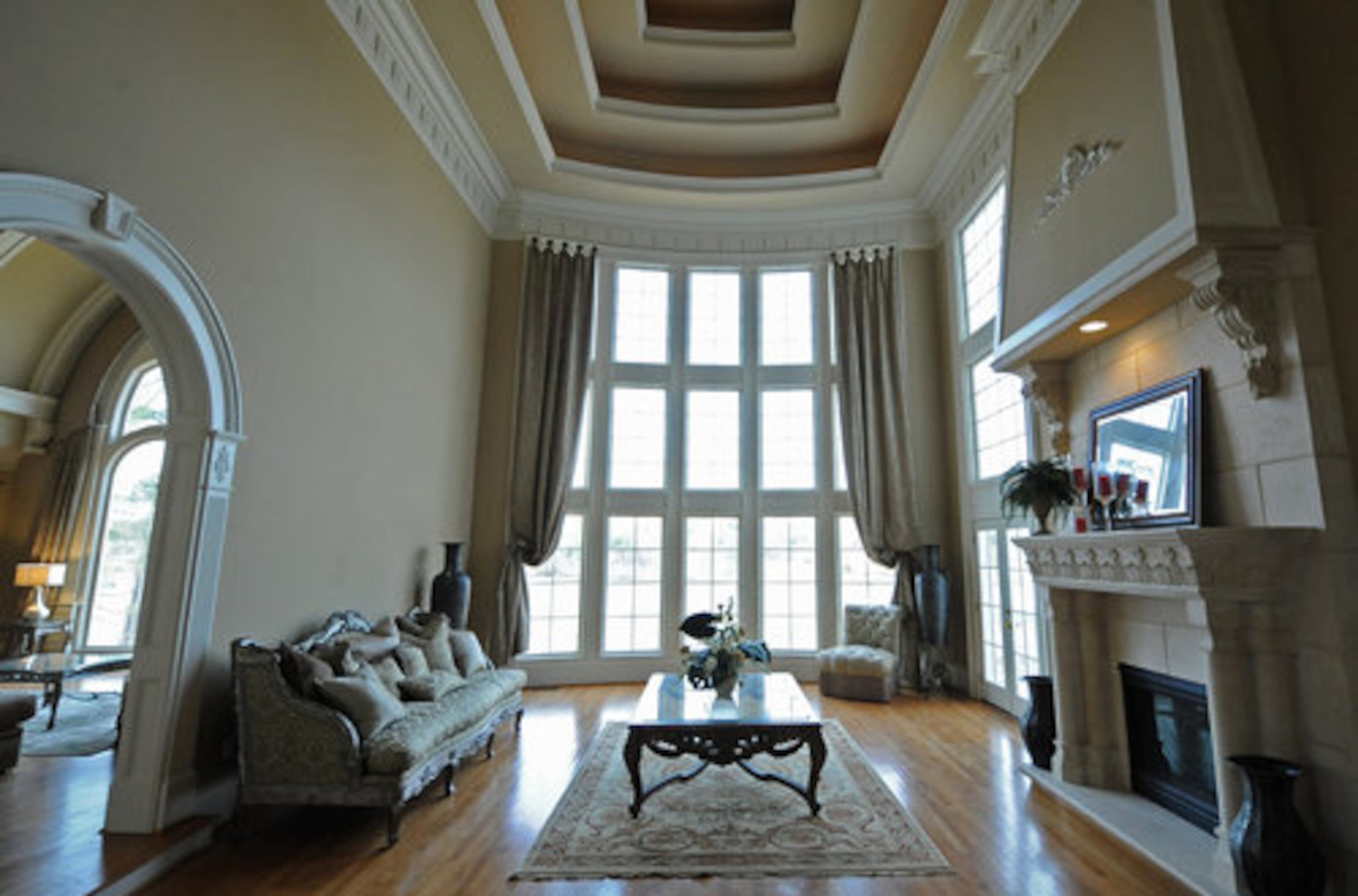 Two-story windows and soaring tray ceilings are a grand frame to the home's lake views. Funari realtor Lance Hempen estimates the ceilings to be at least 35 feet.