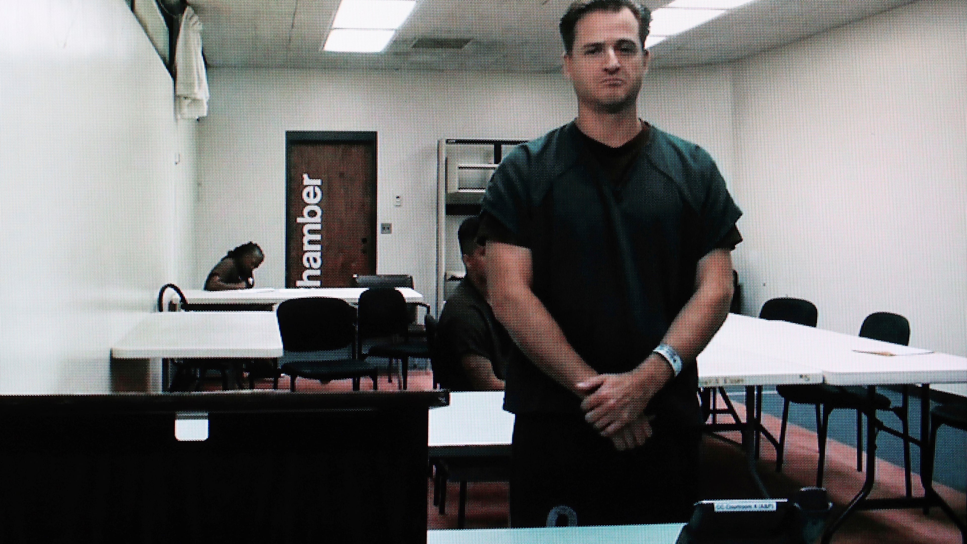 FILE - Hawaii doctor Gerhardt Konig appears before a judge via video during an arraignment hearing after being indicted on allegation of attempting to kill his wife, April 7, 2025, in Honolulu. (AP Photo/Marco Garcia, File)