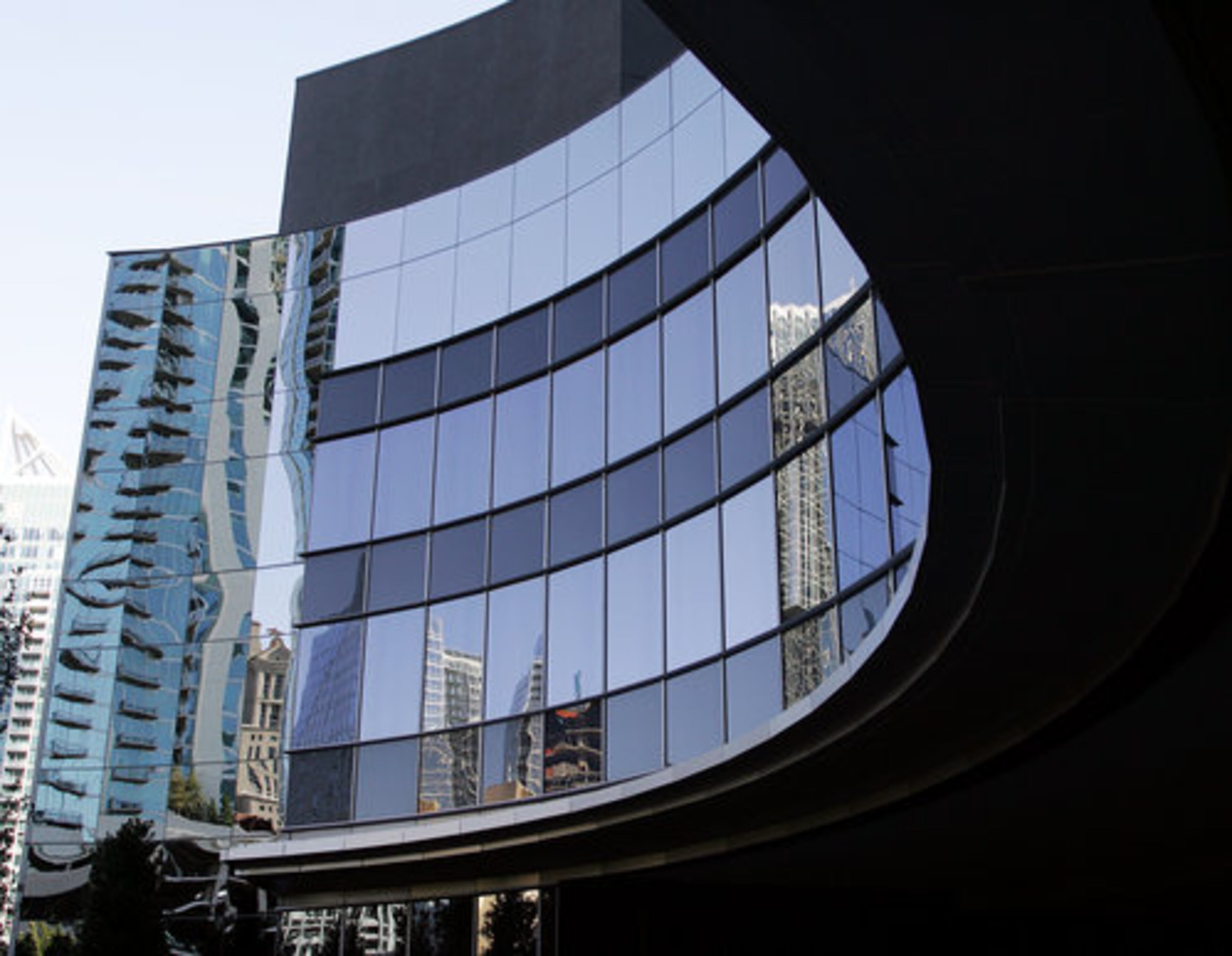 The curved glass building with the blue hue includes 82 condominiums that begin at $1 million. It has pricey artwork by Todd Murphy and Michael Stipe, the R.E.M. front man.