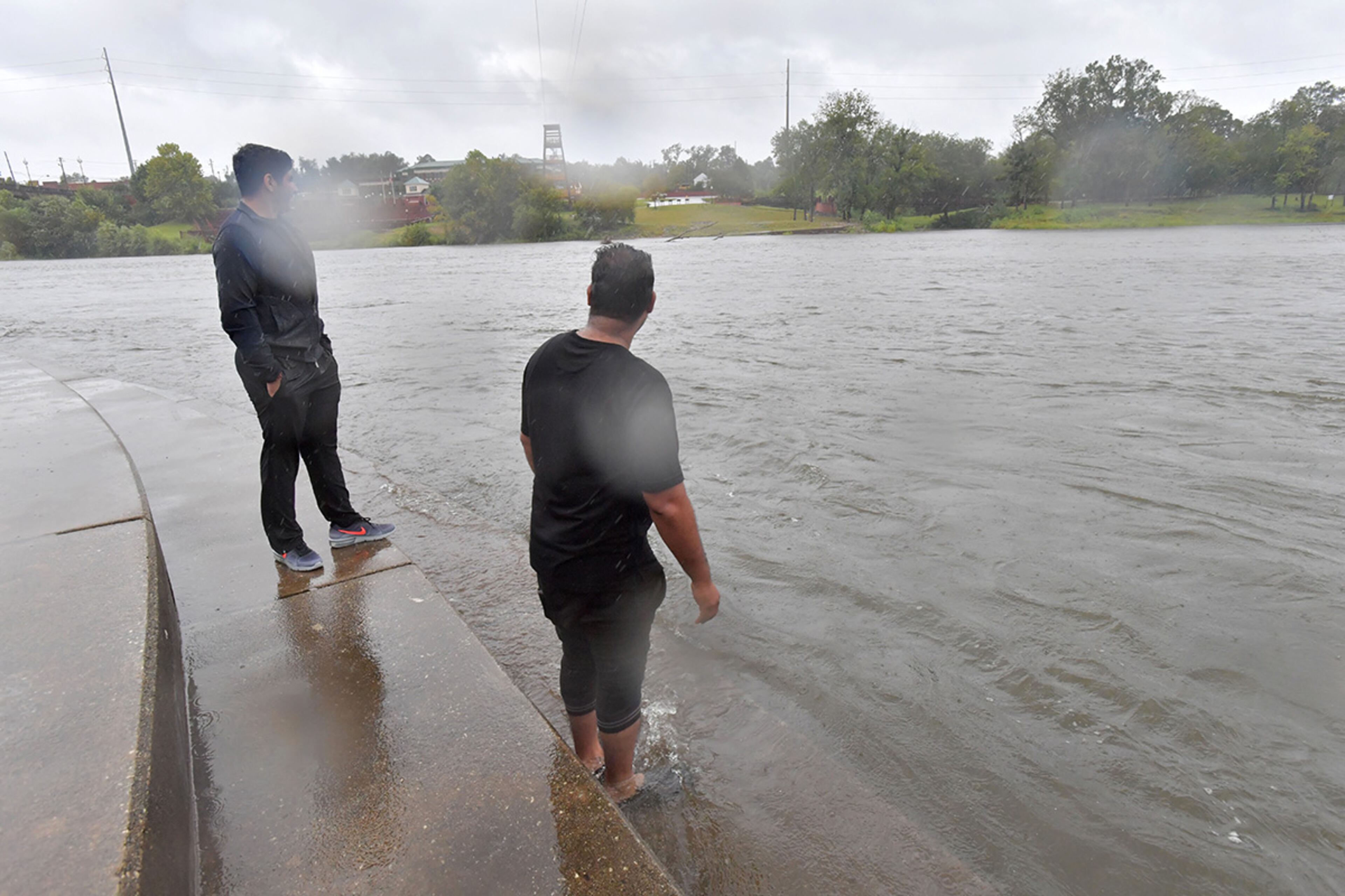 September 11, 2017 Columbus - Smir Suiai (left) and Munib Riaz, both students at Columbus State University, check out rising water near the school campus in uptown Columbus ahead of Hurricane Irma on Monday, September 11, 2017. The Georgia coast was hit hard Monday morning, with pounding rains, roaring winds and storm surge. More than 87,000 Georgia Power customers were without power in the Savannah area, as were another 96,000 from Brunswick and St. Simons south to St. Marys, at the Florida line. HYOSUB SHIN / HSHIN@AJC.COM