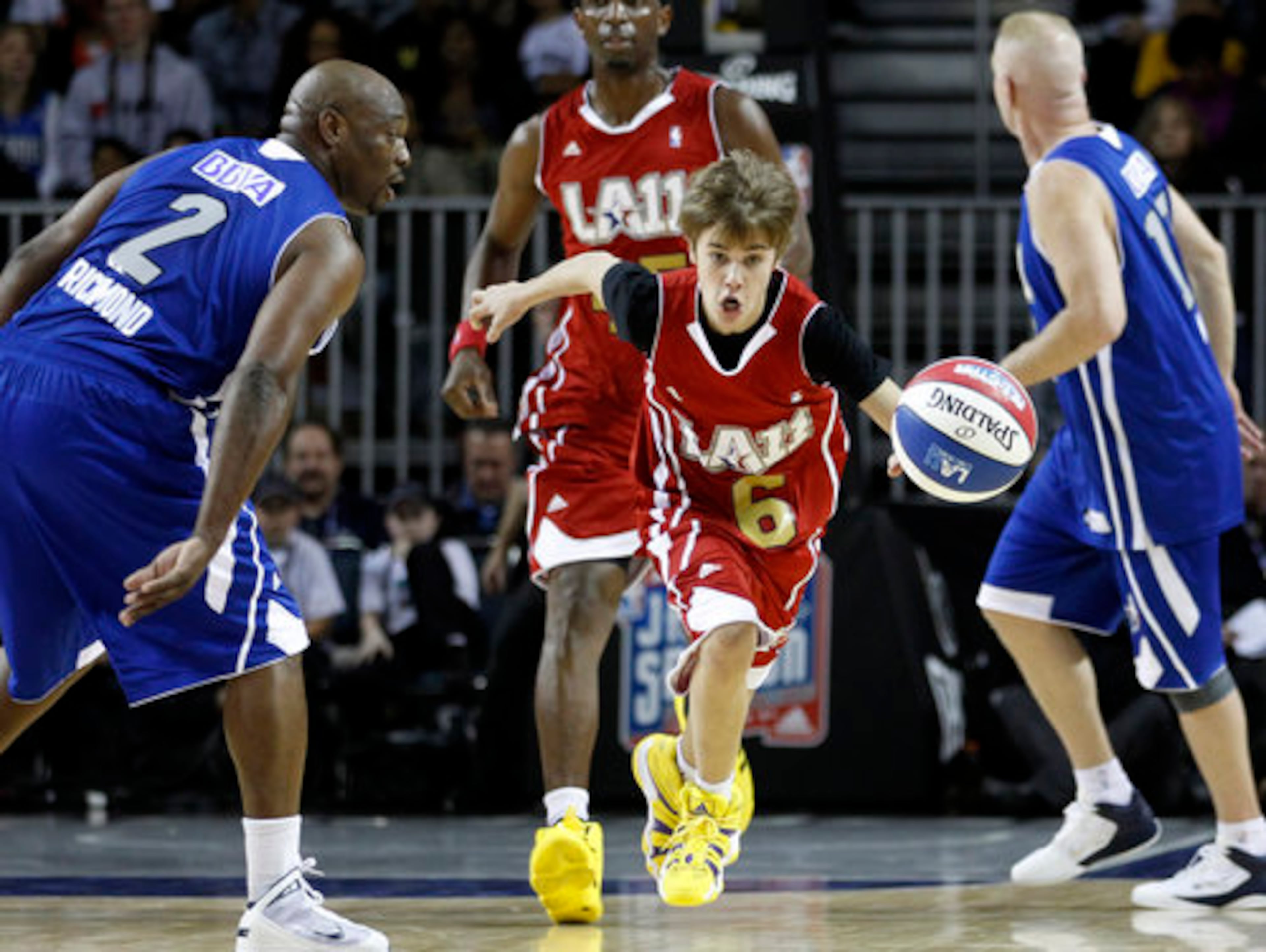 Singer Justin Bieber, center, makes his way down the court during a BBVA All-Star celebrity basketball game at the NBA All Star Weekend in Los Angeles, Friday, Feb. 18, 2011.