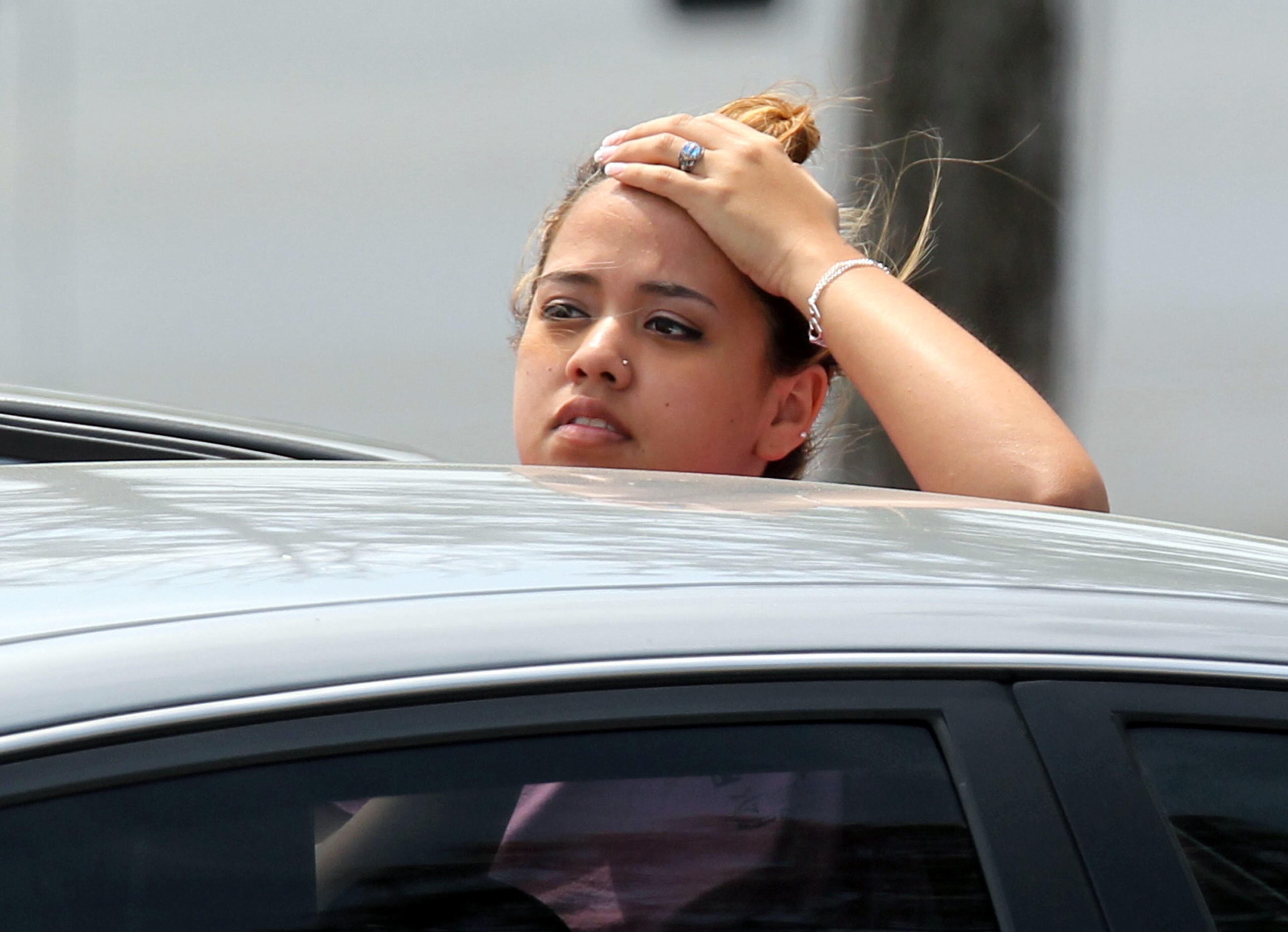 A student waits to leave Lone Star College's Cy-Fair campus in Cypress, Texas, where a student went on a building-to-building stabbing attack on April 9, 2013. The attacker wounded at least 14 people before being subdued and arrested, authorities said.
