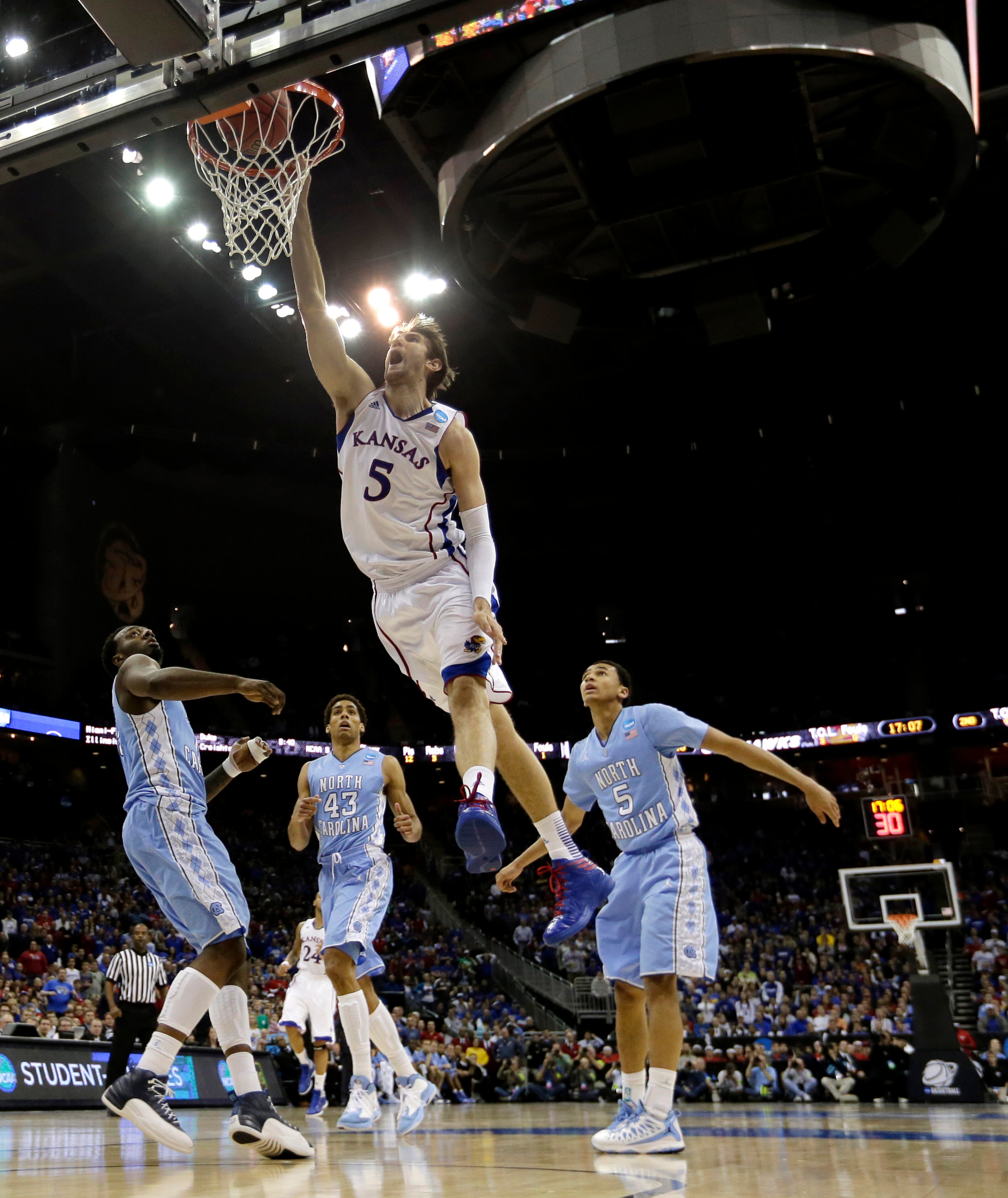 Kansas center Jeff Withey (5) dunks the ball during the second half of a third-round game against North Carolina in the NCAA college basketball tournament Sunday, March 24, 2013, in Kansas City, Mo. Kansas won the game 70--58. (AP Photo/Charlie Riedel)