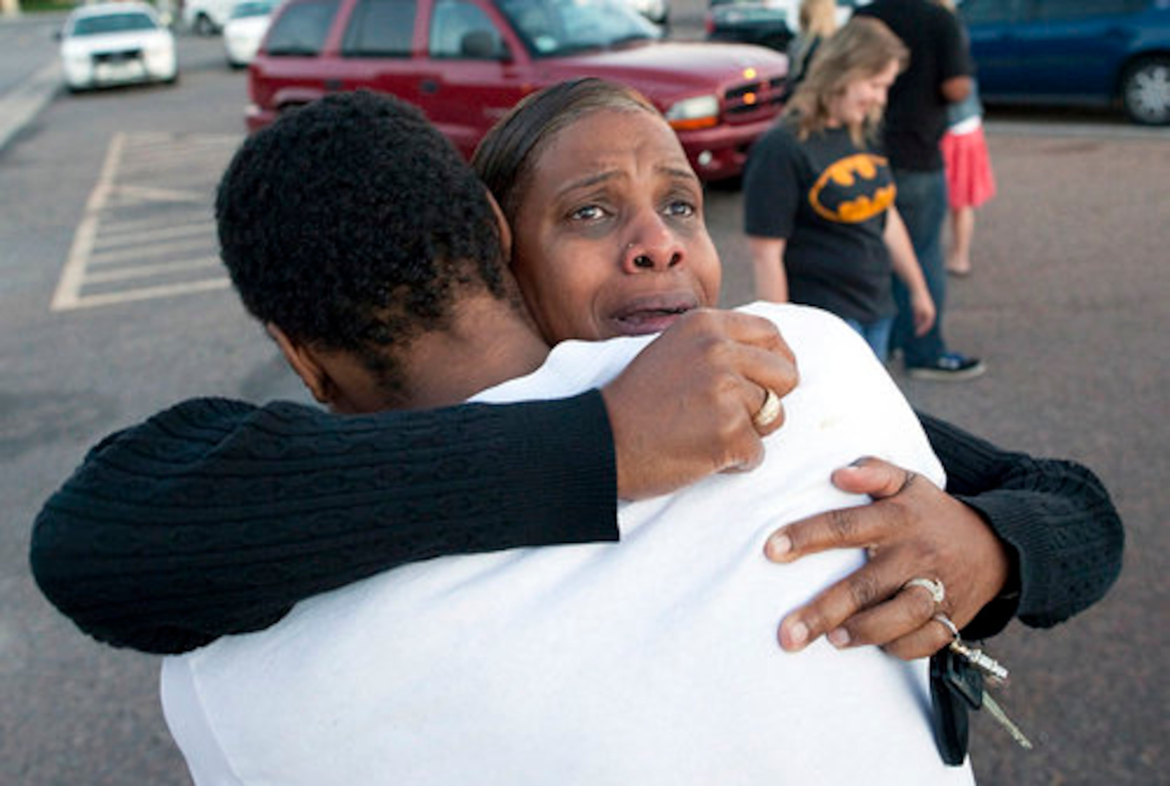 Shamecca Davis hugs her son Isaiah Bow, who was an eye witness to the shooting.