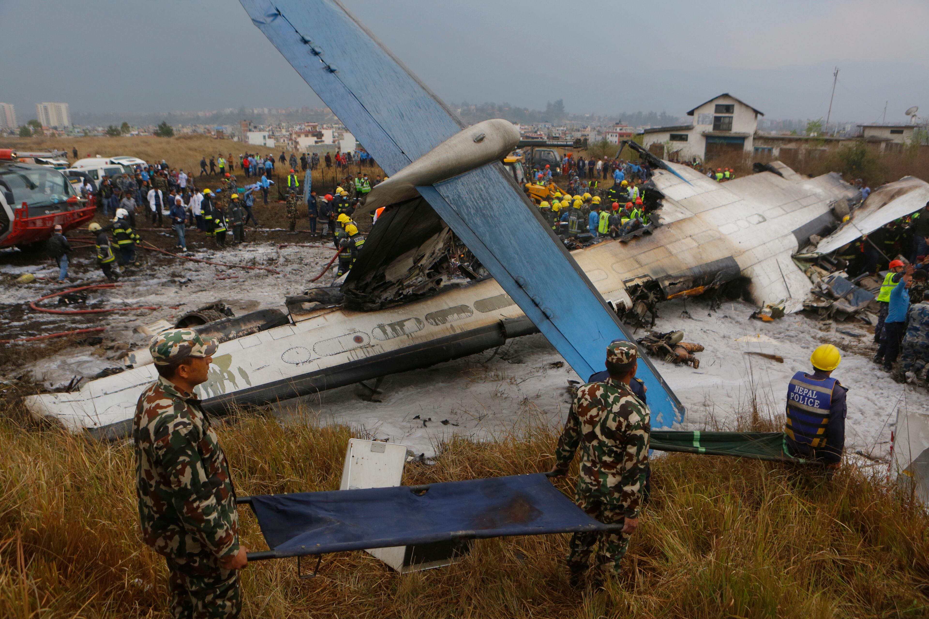 Nepalese rescuers work after a passenger plane from Bangladesh crashed at the airport in Kathmandu, Nepal, Monday, March 12, 2018. The passenger plane carrying 71 people from Bangladesh crashed and burst into flames as it landed Monday in Kathmandu, Nepal's capital, killing dozens of people, officials said. (AP Photo/Niranjan Shreshta)