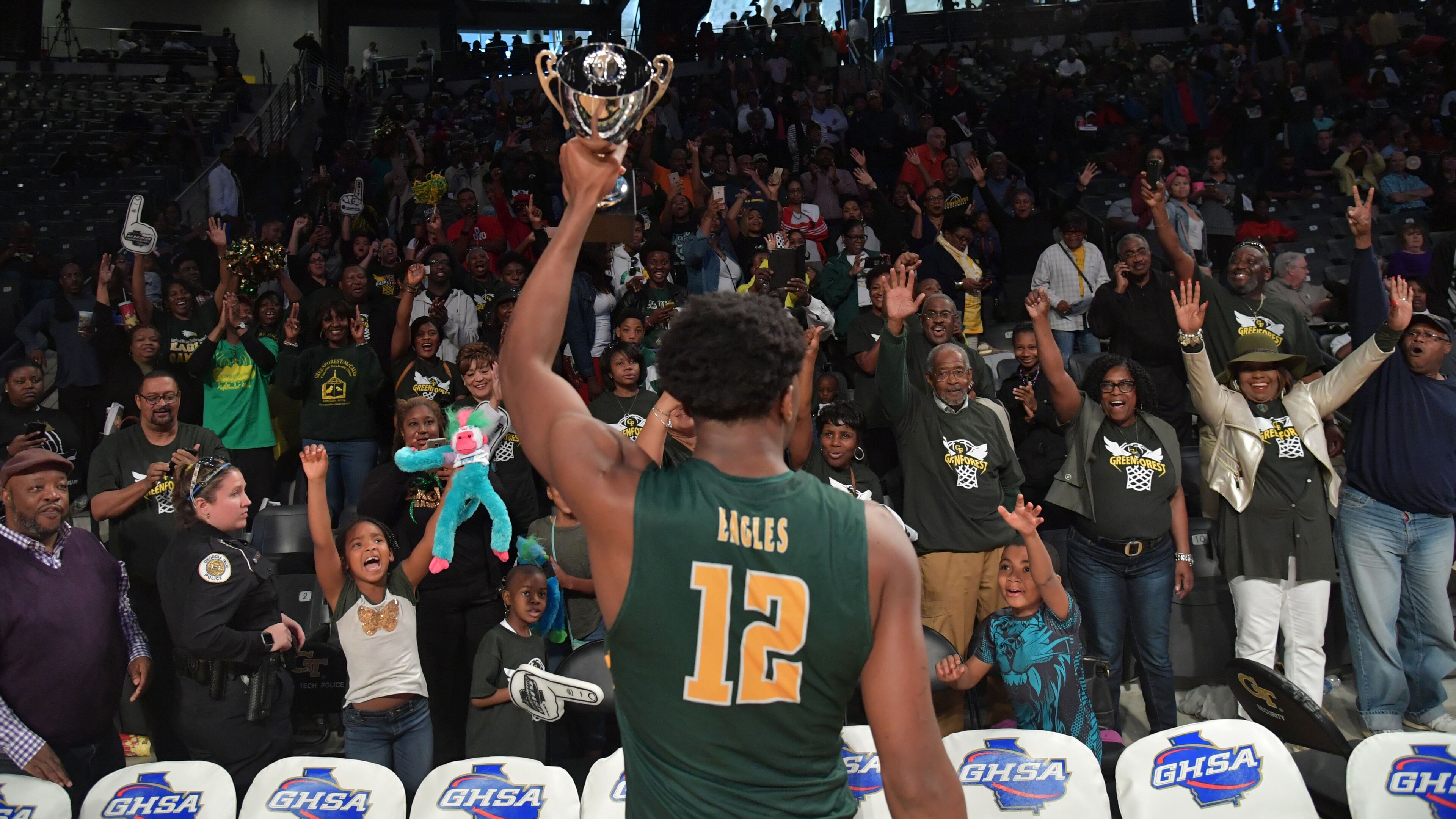 Greenforest's Victor Enoh (12) celebrates with fans in GHSA 2017 State Basketball Championship game at Georgia Tech's McCamish Pavilion on Friday, March 10, 2017. Greenforest won 81 - 57 over the Southwest Atlanta Christian.