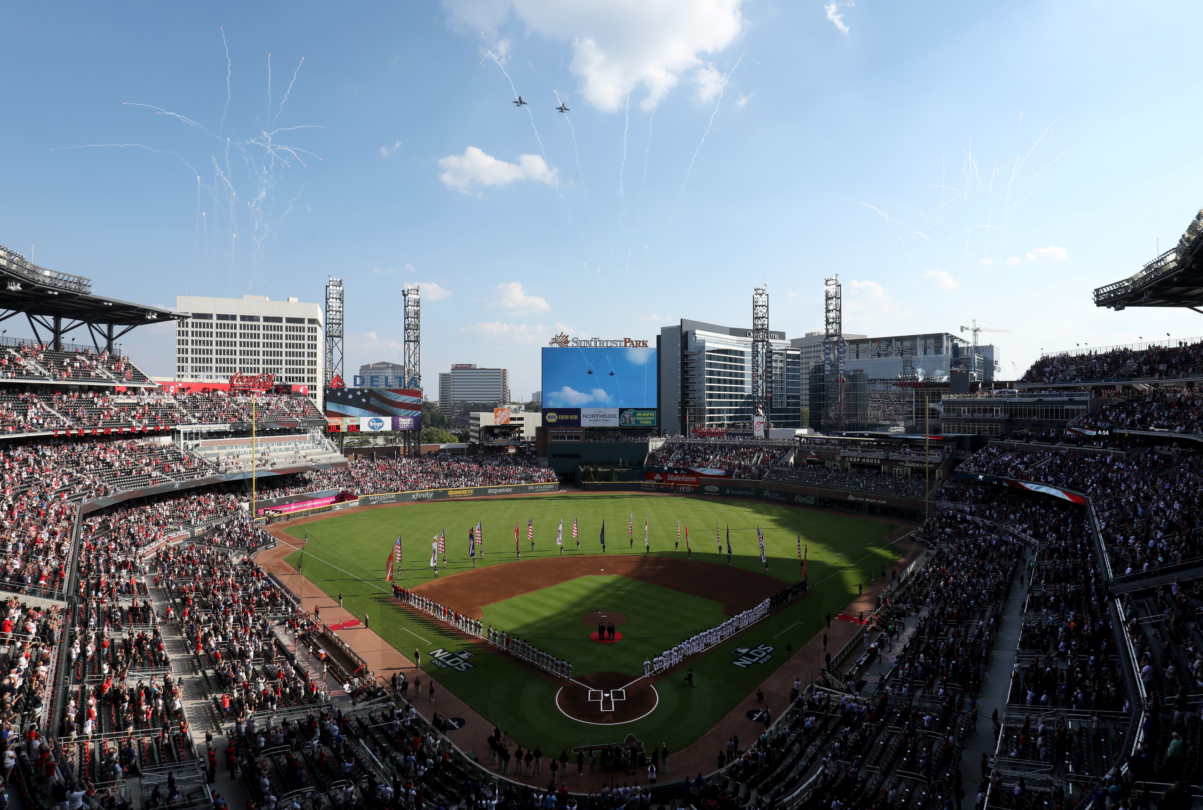 Military jets fly over the stadium. (JASON GETZ/SPECIAL TO THE AJC)