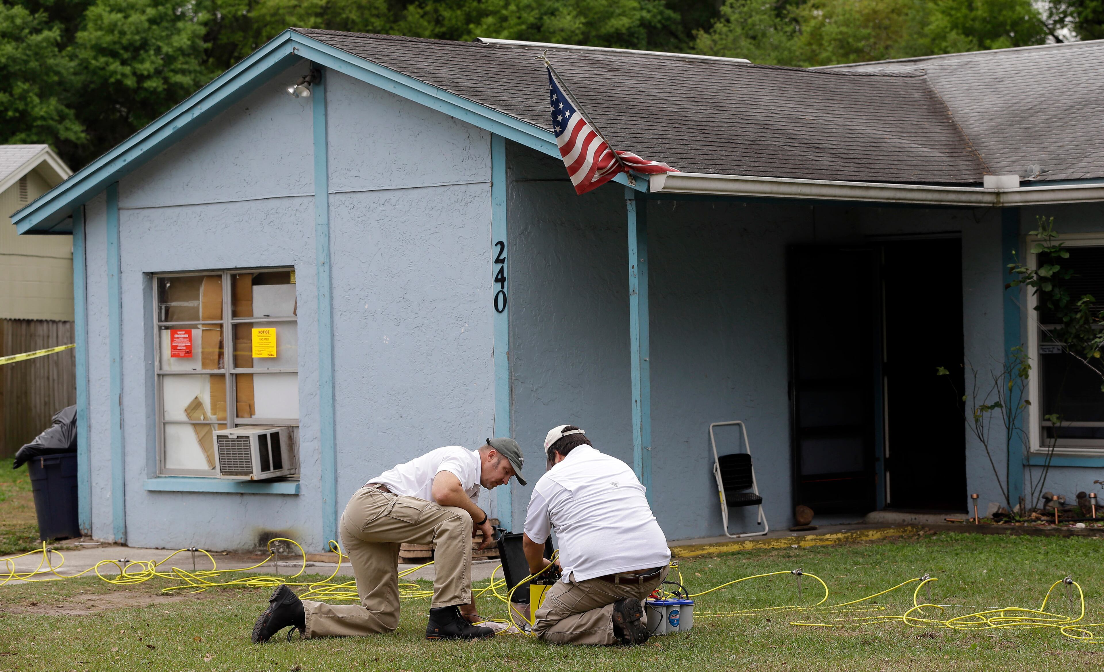 Engineers work in front of the home.