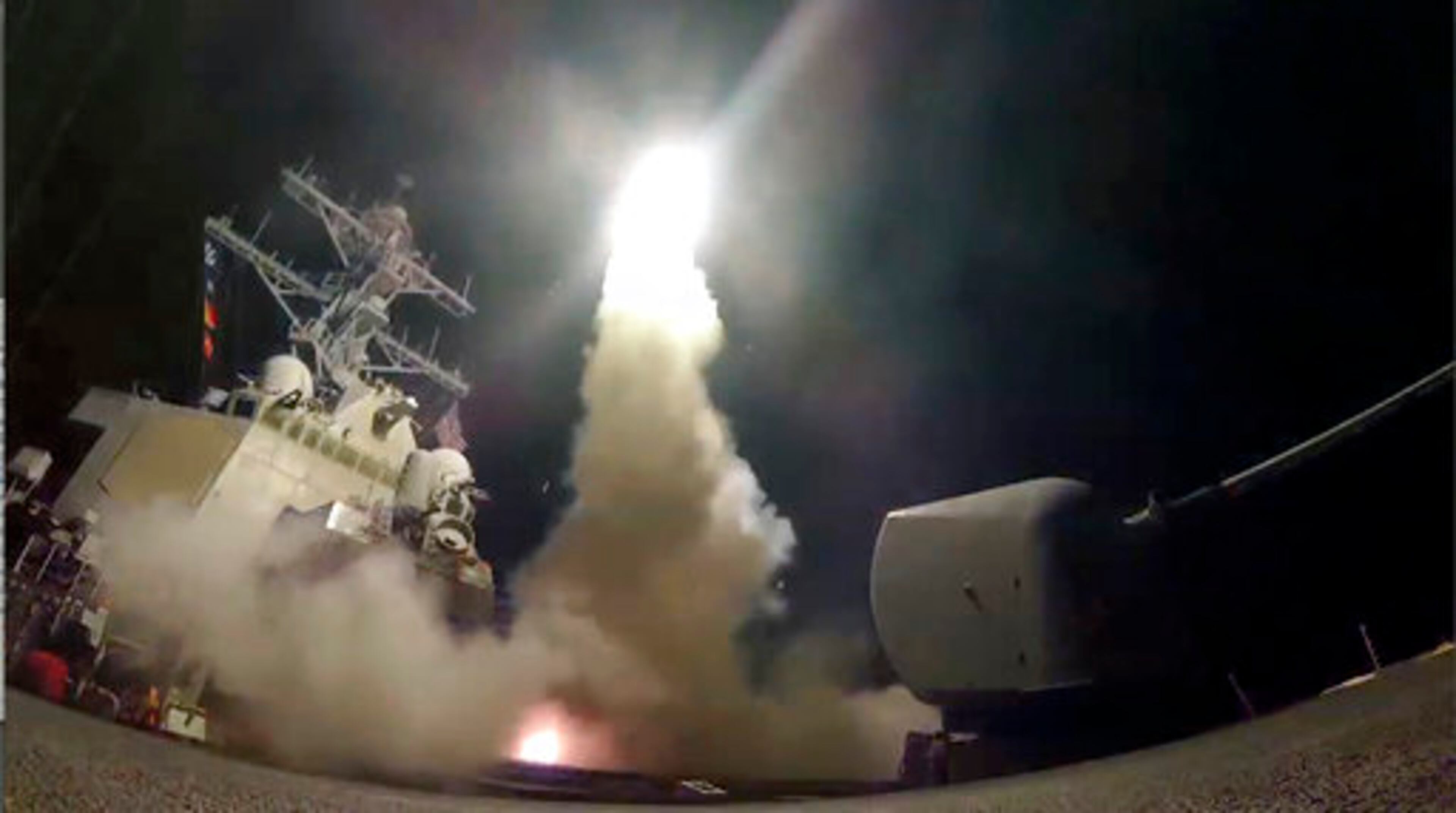 In this image from video provided by the U.S. Navy, the guided-missile destroyer USS Porter (DDG 78) launches a tomahawk land attack missile in the Mediterranean Sea, Friday, April 7, 2017. The United States blasted a Syrian air base with a barrage of cruise missiles in fiery retaliation for this week's gruesome chemical weapons attack against civilians. (Mass Communication Specialist 3rd Class Ford Williams/U.S. Navy via AP)