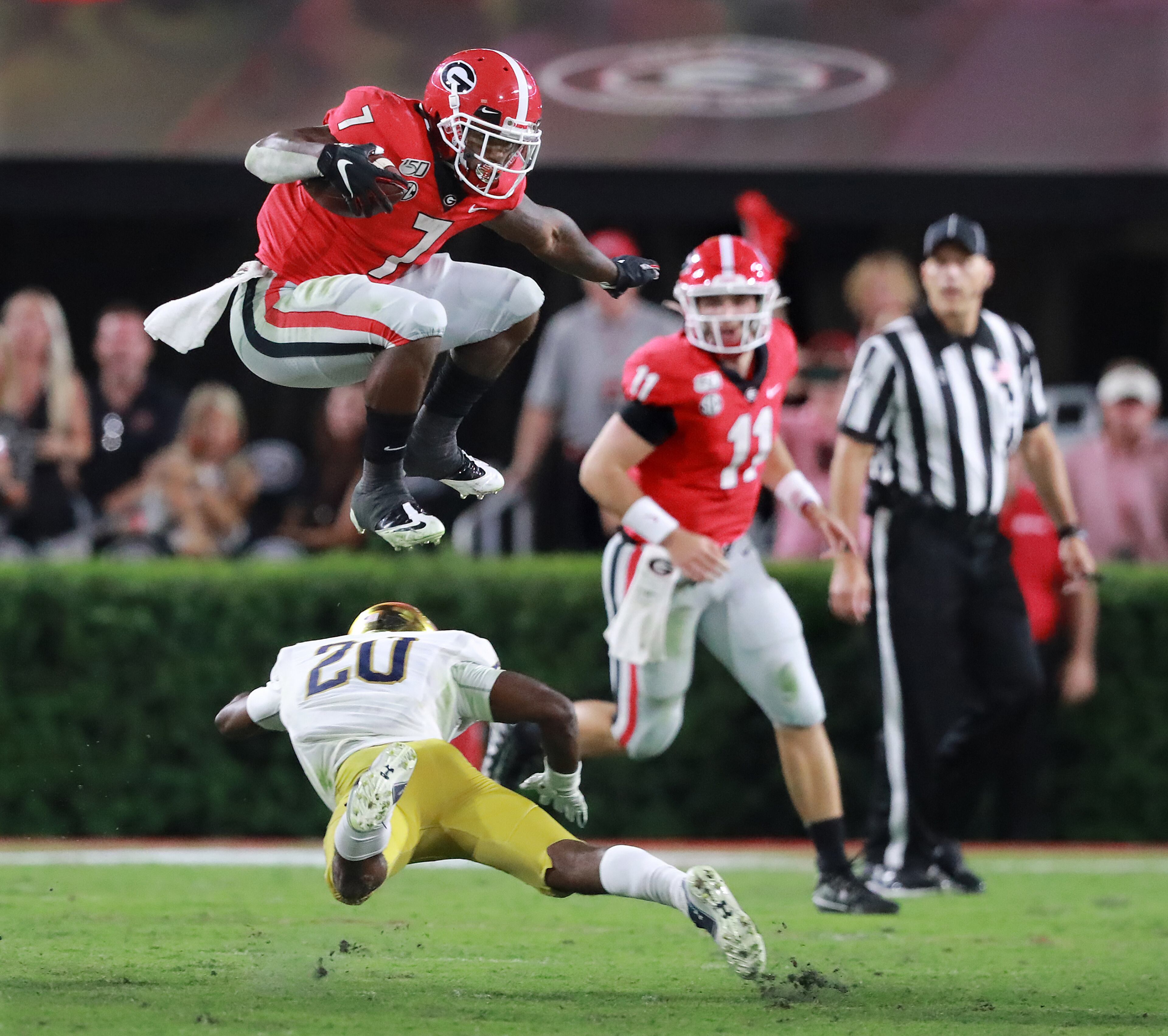 D'Andre Swift leaps over Notre Dame cornerback Shaun Crawford. Curtis Compton/ccompton@ajc.com