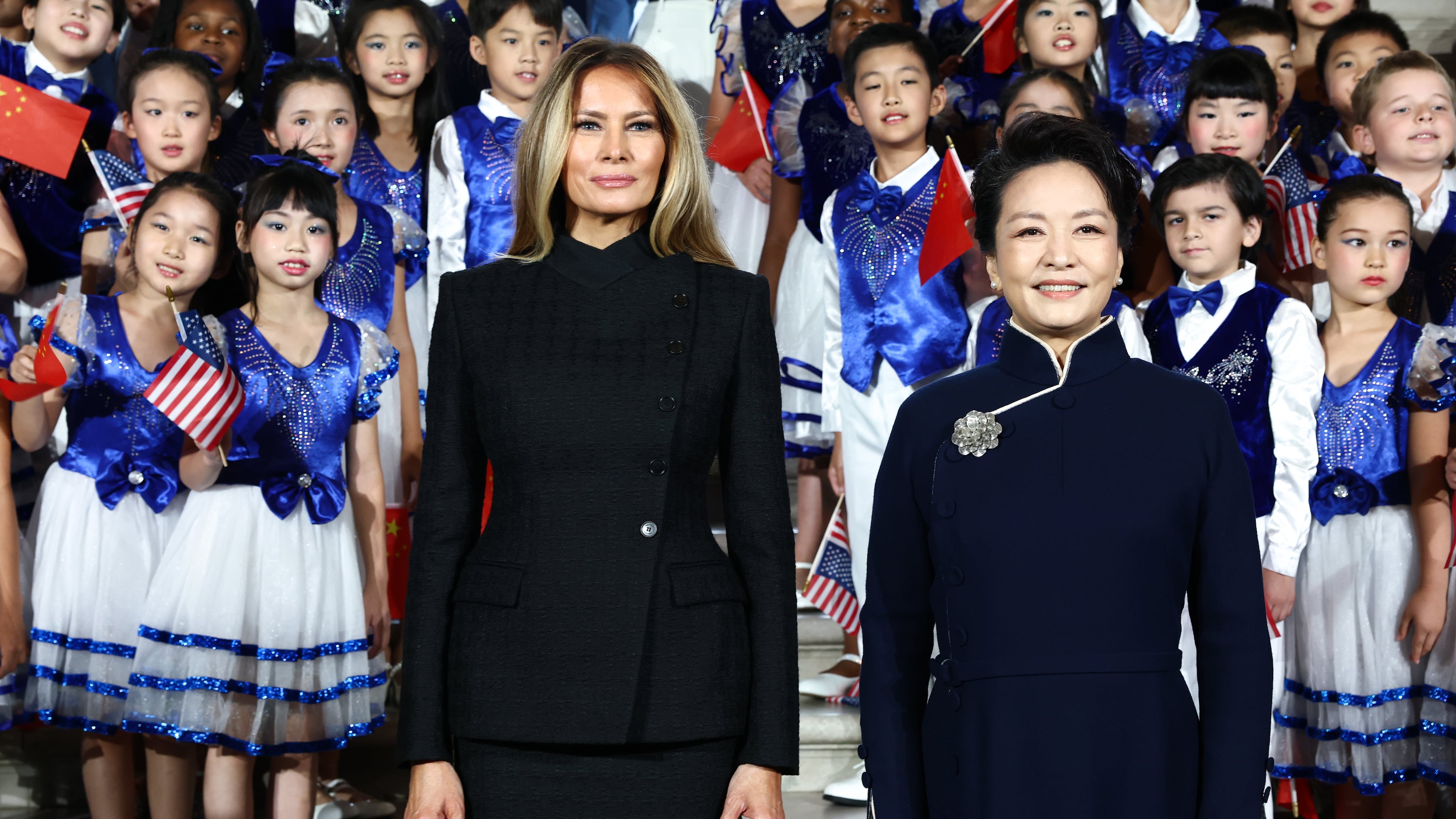 First lady of China Peng Liyuan, right, and first lady Melania Trump, pose for a photo with choir students from the Hope Chinese School at the Smithsonian's National Museum Of Asian Art, Thursday, Sept. 24, 2026, in Washington. (Finn Gomez/Pool Photo via AP)