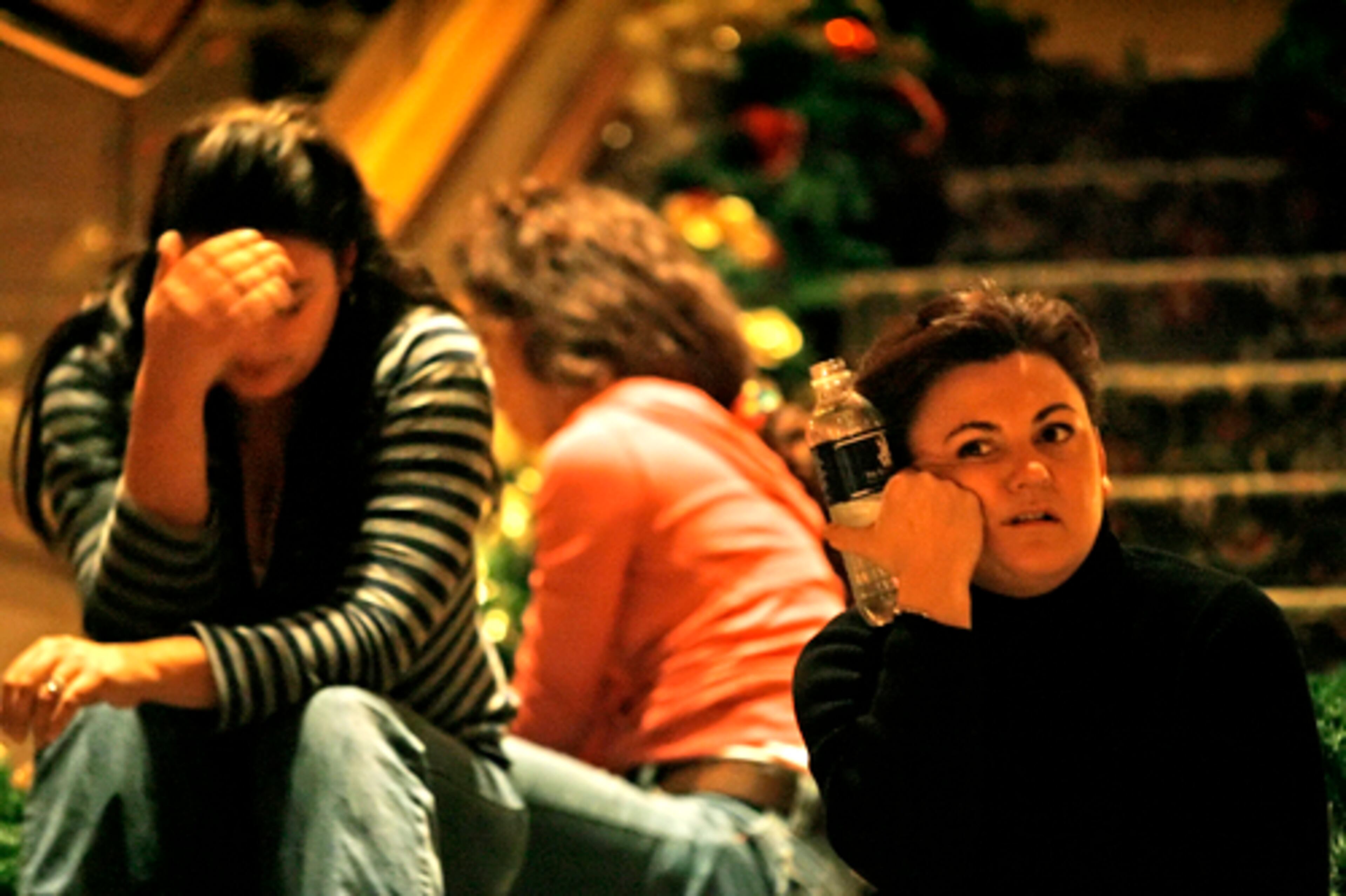Theresa Williams (right) and one of her helpers, Dacia Urban (left) take a moment while getting the garland ready for the grand staircase.