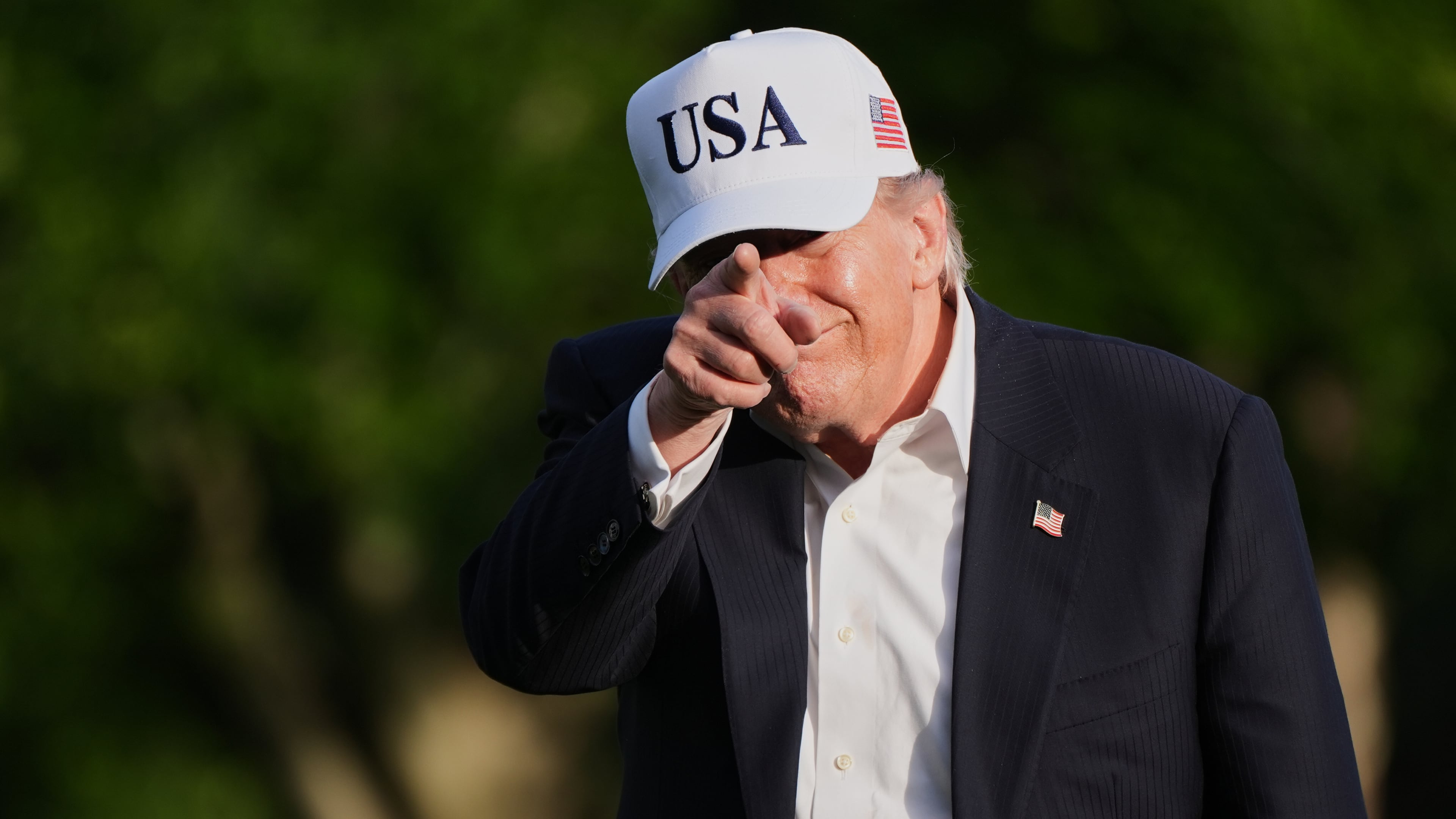 President Donald Trump gestures to reporters as he walks across the South Lawn of the White House, Friday, May 15, 2026, in Washington, on return from Beijing where he met with China's President Xi Jinping. (AP Photo/Jacquelyn Martin)