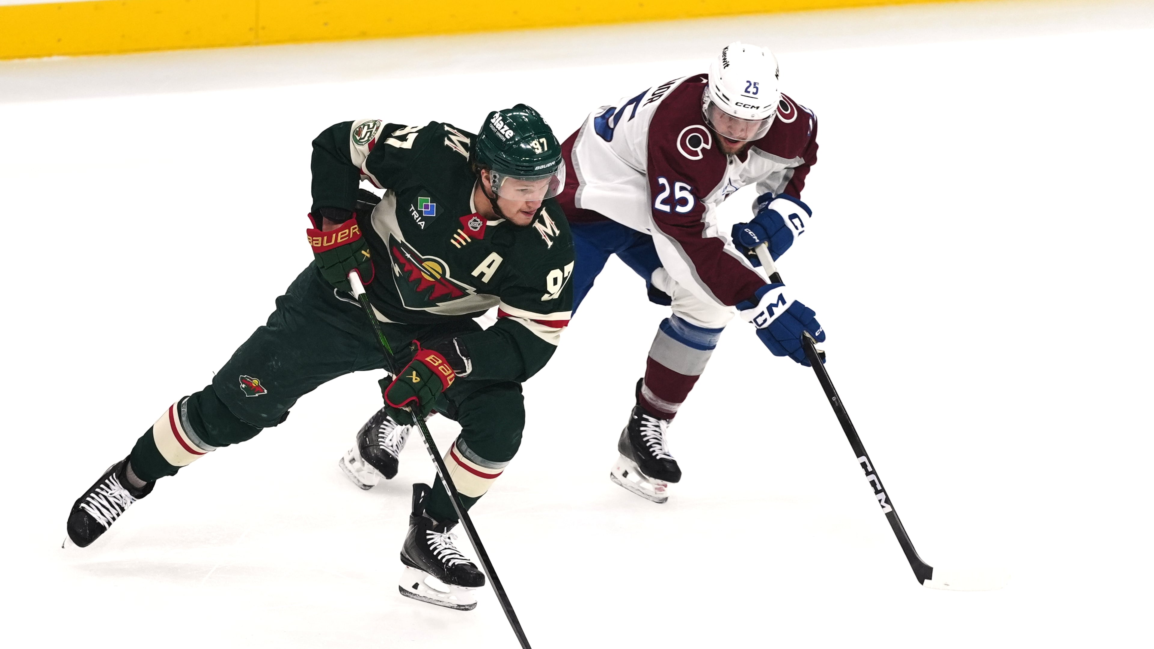 Minnesota Wild left wing Kirill Kaprizov (97) skates with the puck as Colorado Avalanche right wing Logan O'Connor (25) defends during the first period of Game 3 of an NHL Stanley Cup hockey second-round playoff series Saturday, May 9, 2026, in St. Paul, Minn. (AP Photo/Abbie Parr)