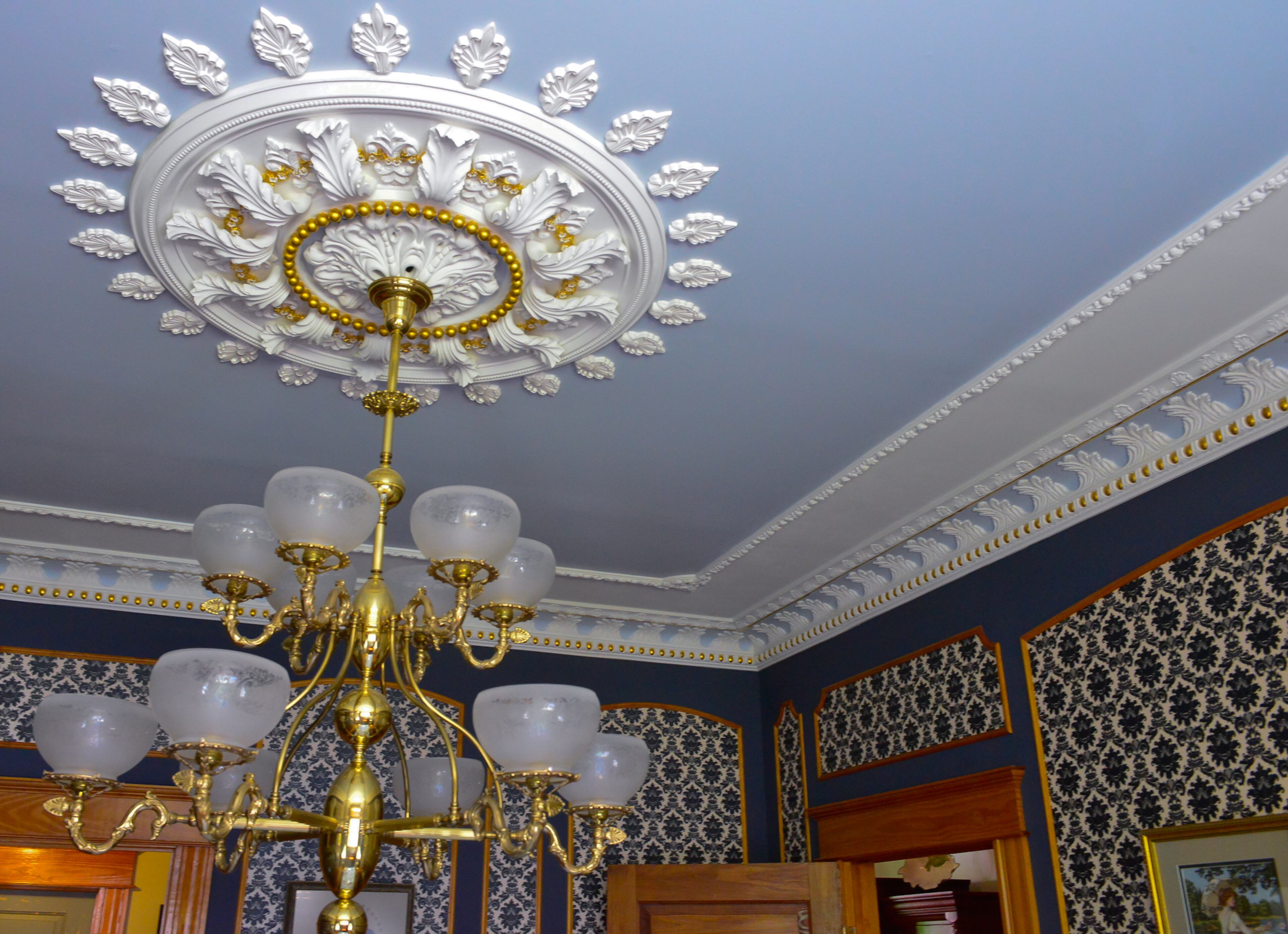 In the dining room, the plaster medallion was added to the ceiling and moldings were added to the walls by homeowners Mike and Carolyn Dufano in 2007.