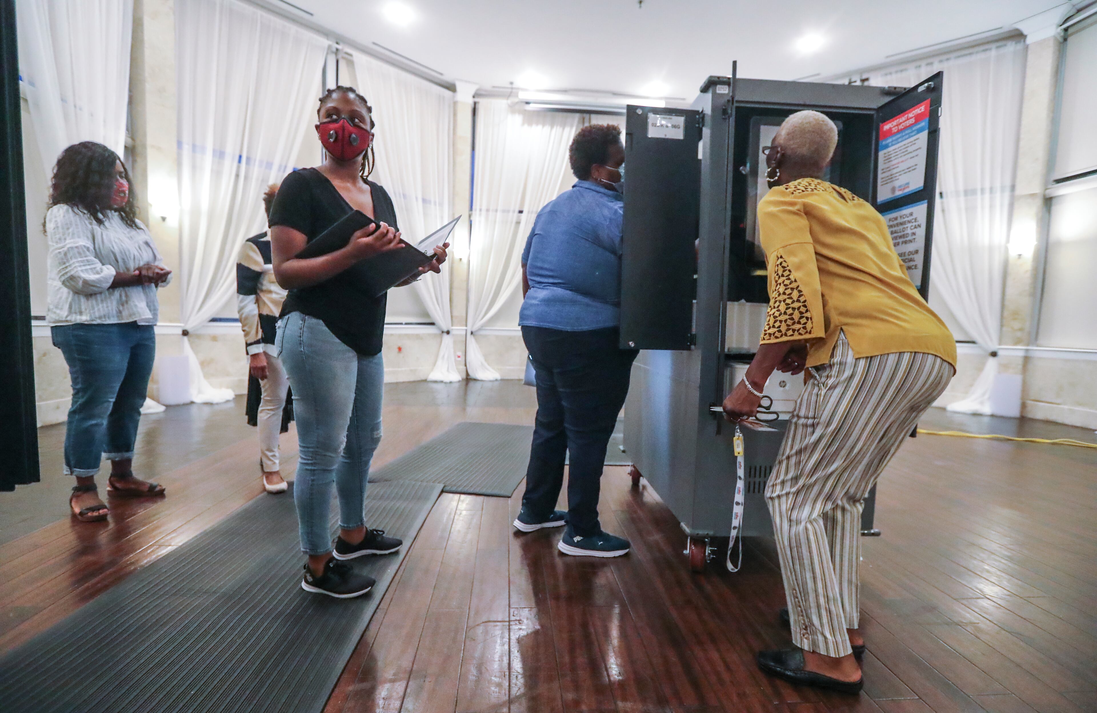 August 11, 2020 Atlanta: Poll workers prepare machines on Tuesday, August 11, 2020 at Park Tavern located at 500 10th St NE in Atlanta. A heated race for Fulton County district attorney saw a light turnout at the polls on Tuesday, August 11, 2020. Incumbent Paul Howard faces his former chief deputy, Fani Willis, in a closely watched contest to become the county’s top prosecutor. Election officials said they learned lessons from the June 9 primary to avoid the kind of extreme lines that some voters encountered last time. Poll workers have been retrained. Technicians were on hand at every voting location in Cobb, DeKalb, Fulton and Gwinnett counties. Voting machines were delivered well in advance of election day. Still, some voters experienced problems and long waits at the polls. Nearly 377,000 Georgians already voted in advance of election day, most of them casting absentee ballots. About 60% of early votes were absentee; the rest were cast in person during three weeks of early voting. With so many voters using absentee ballots, election results might be slow to come in Tuesday night. Absentee ballots will be counted if they’re received by county election officials before 7 p.m., but each ballot has to be fed through a scanner to be counted, a process that can take days. Election officials say it’s normal for absentee vote-counting to take some time. But that means close races might not be settled on election night. The winners of Tuesday’s runoffs will advance to the general election in November, when turnout is expected to break records and exceed 5 million voters. JOHN SPINK/JSPINK@AJC.COM
