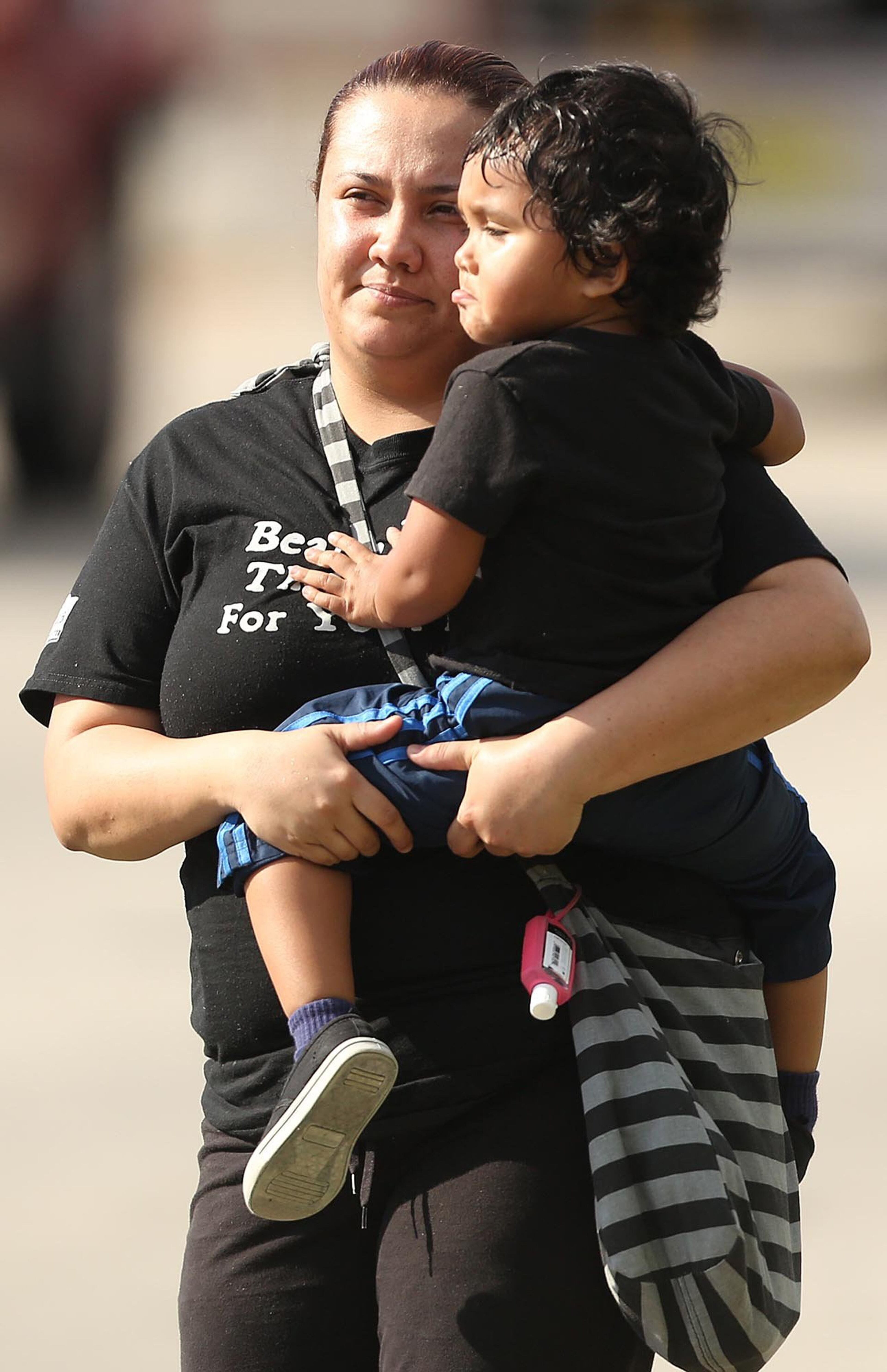 Children are escorted by their parents from the KinderCare Learning Center in Winter Park, Fla.(Stephen M. Dowell, Orlando Sentinel/MCT)