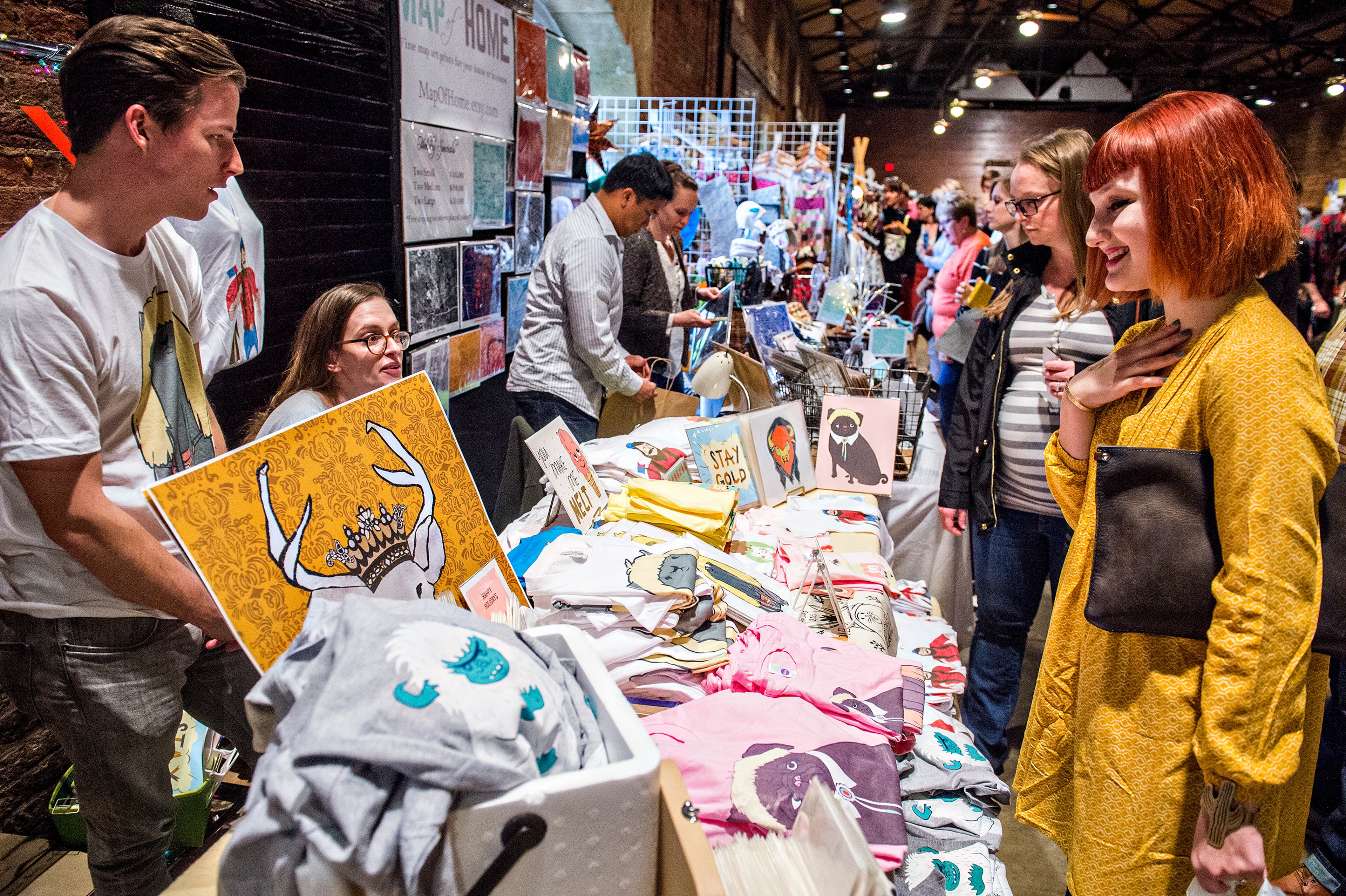 November 21, 2015 Atlanta - Abbie Stein (right) talks with Lucy Ricketts and Brandon Steffens during the Indie Craft Experience's Holiday Shopping Spectacular at the Georgia Freight Depot in Atlanta on Saturday, November 21, 2015. The 11th annual arts festival featured local and regional artists, food, music and holiday cheer. JONATHAN PHILLIPS / SPECIAL