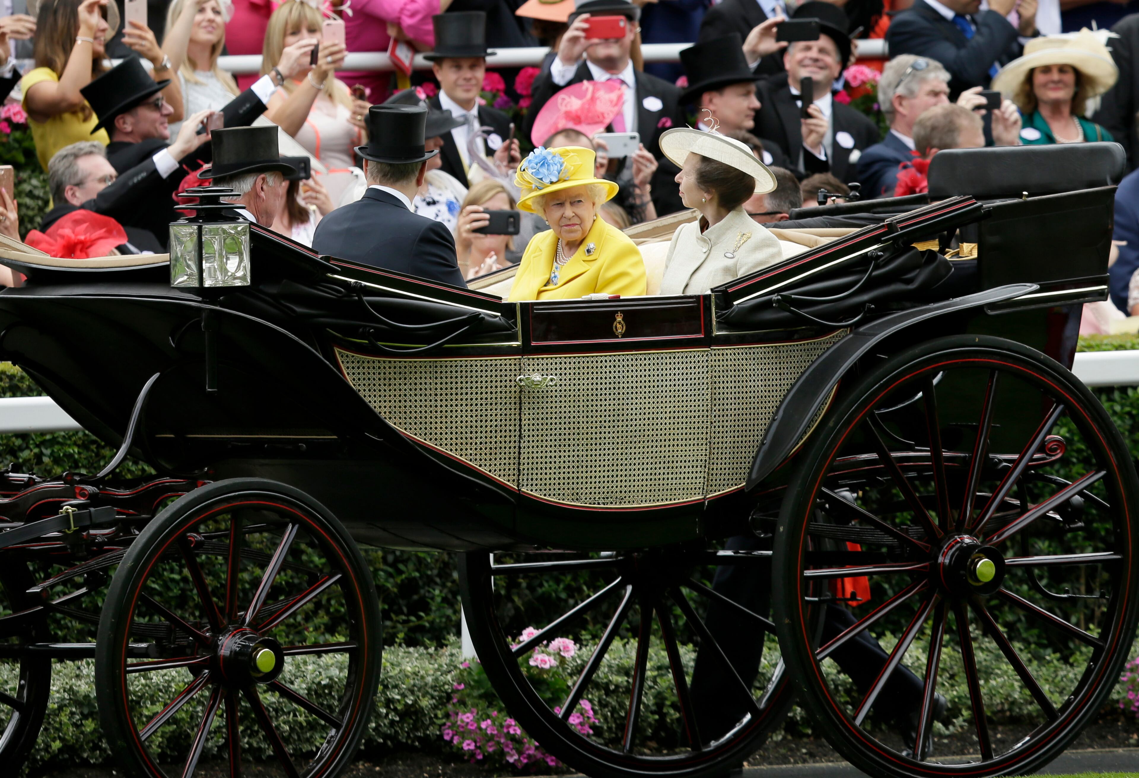 Britain's Queen Elizabeth II arrives at the parade ring with Anne, Princess Royal, in a horse drawn carriage, on the first day of the Royal Ascot horse race meeting in Ascot, England, Tuesday, June 19, 2018. (AP Photo/Tim Ireland)