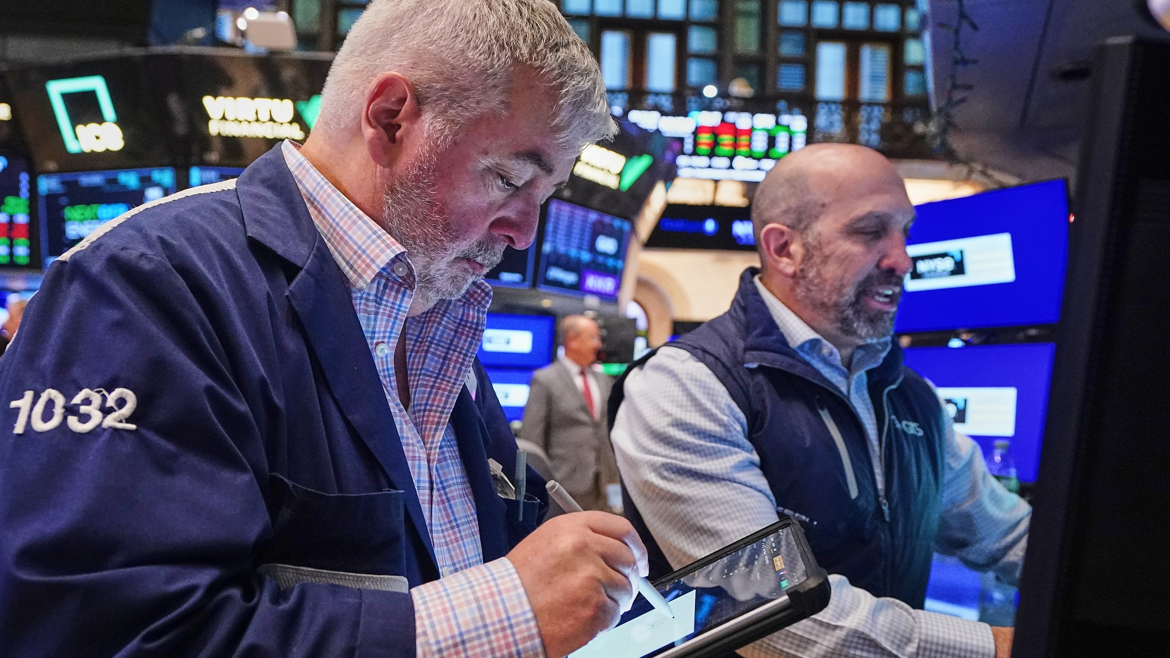 Trader Edward McCarthy, lefty dn specialist James Denaro work on the floor of the New York Stock Exchange, Wednesday, April 22, 2026. (AP Photo/Richard Drew)