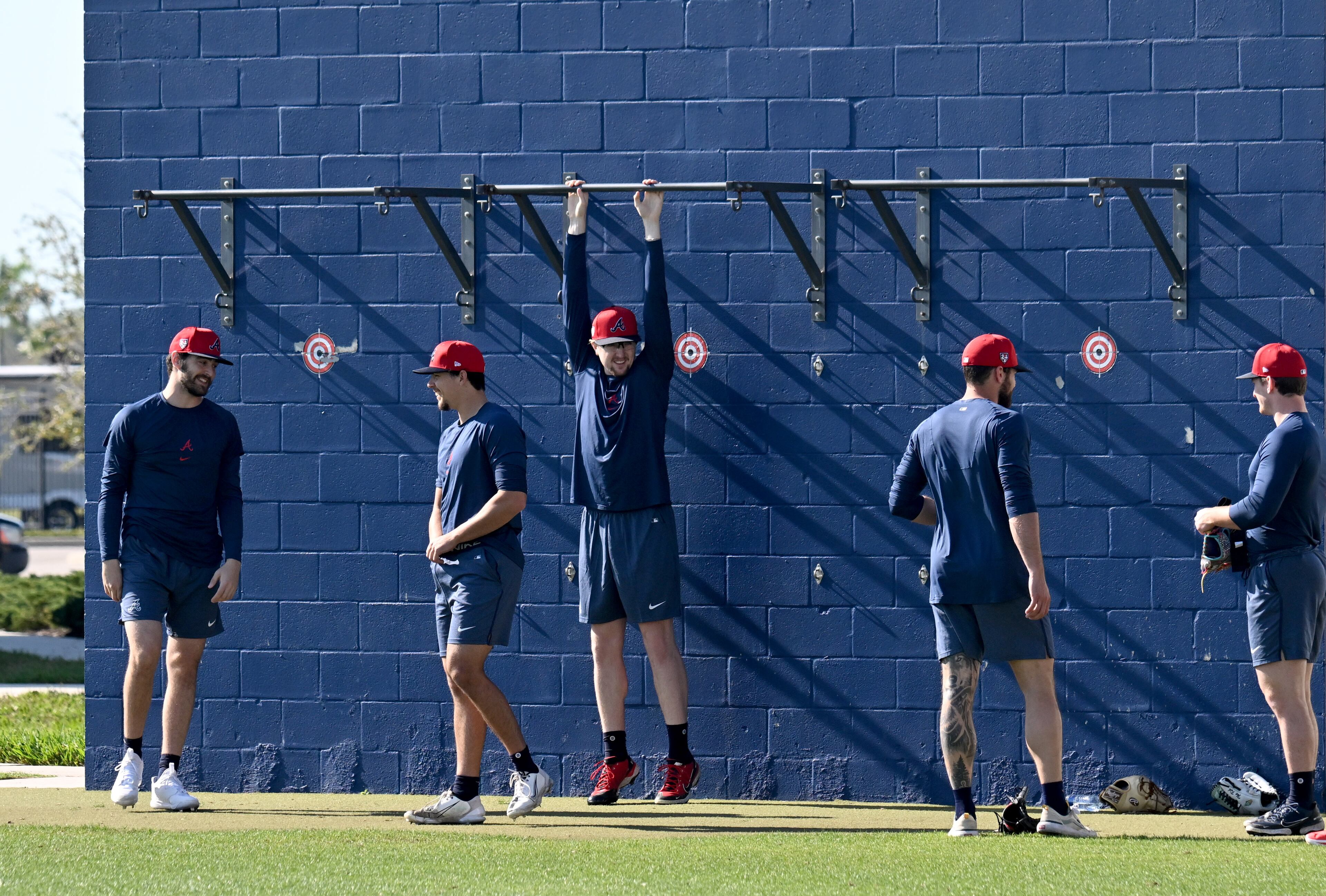 Atlanta Braves players warm up during spring training baseball workouts at CoolToday Park, Thursday, February, 15, 2024, in North Port, Florida. (Hyosub Shin / Hyosub.Shin@ajc.com)