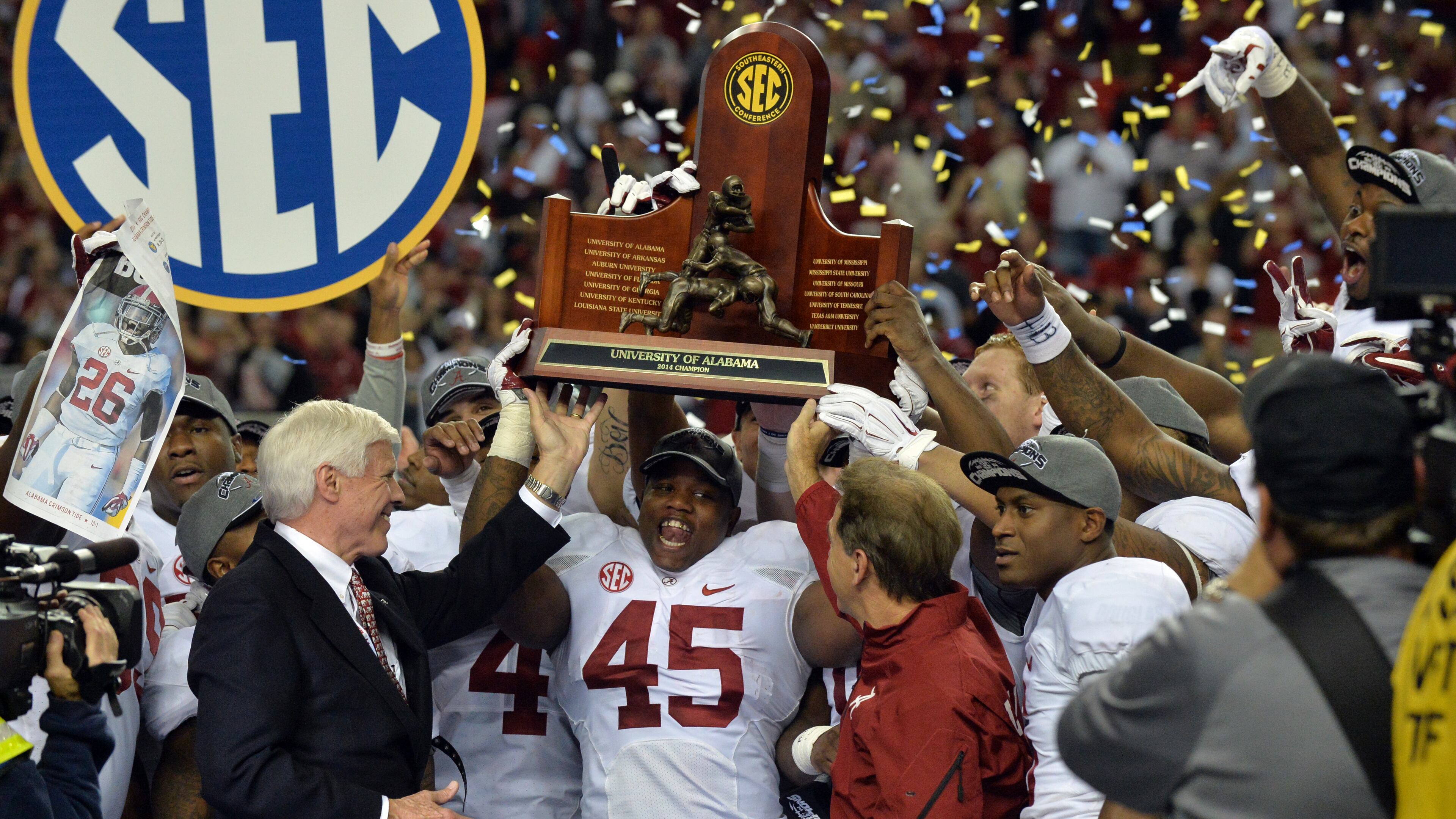December 6, 2014 Atlanta: Alabama Crimson Tide running back Jalston Fowler holds the SEC Championship trophy after defeating Missouri at the Georgia Dome Saturday December 6, 2014. BRANT SANDERLIN / BSANDERLIN@AJC.COM Alabama's SEC championship clinched the No. 1 seed in the playoffs. (Brant Sanderlin/AJC)