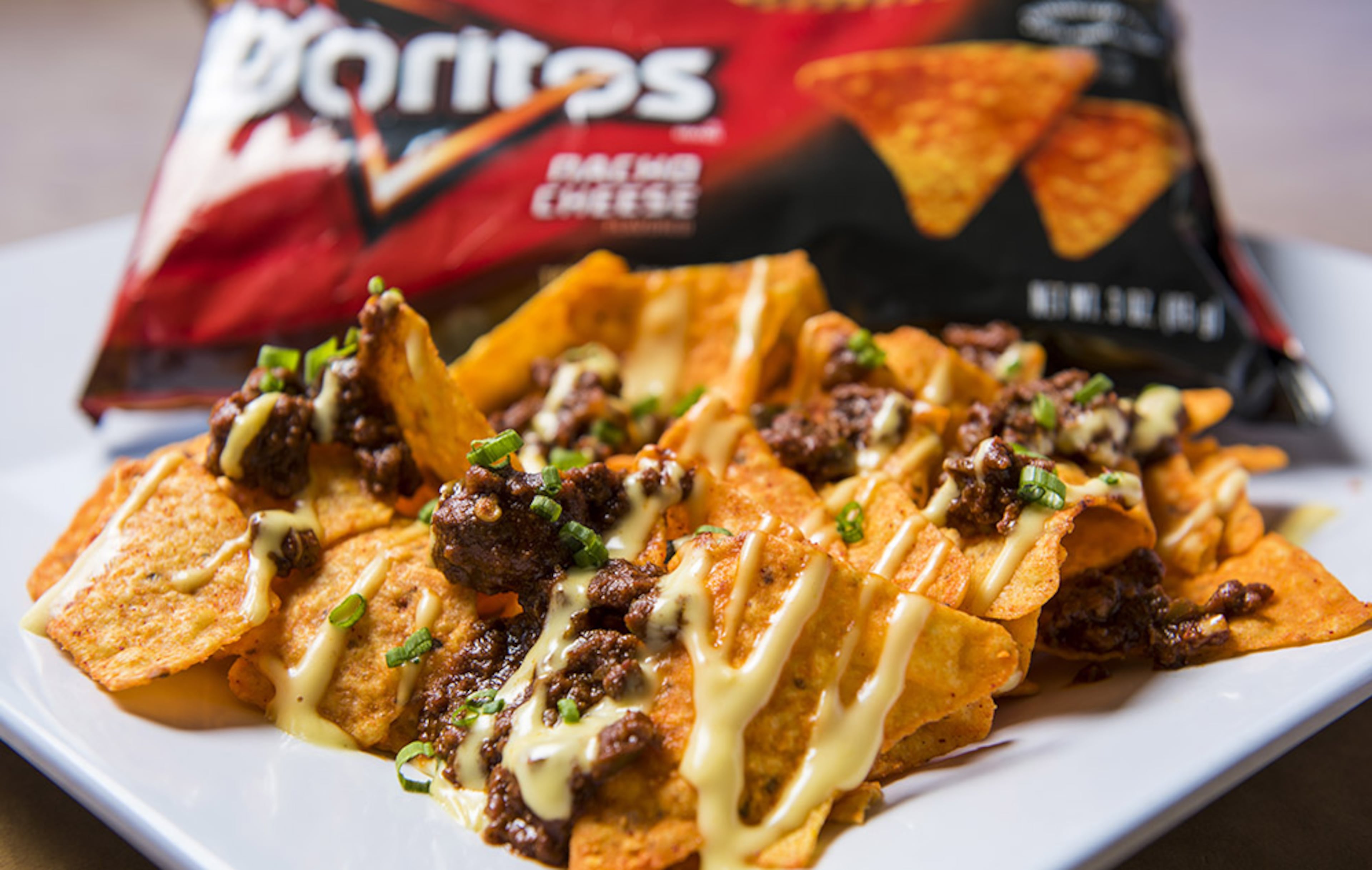 "Top-N-Go," $9, available at Smoke House BBQ in Fan Plaza and Section 317, La Taqueria in Section 321, Nacho Cart in Section 202 -- Your choice of Fritos topped with chili and cheese sauce or Doritos topped with pulled pork, pulled chicken and cheese sauce.