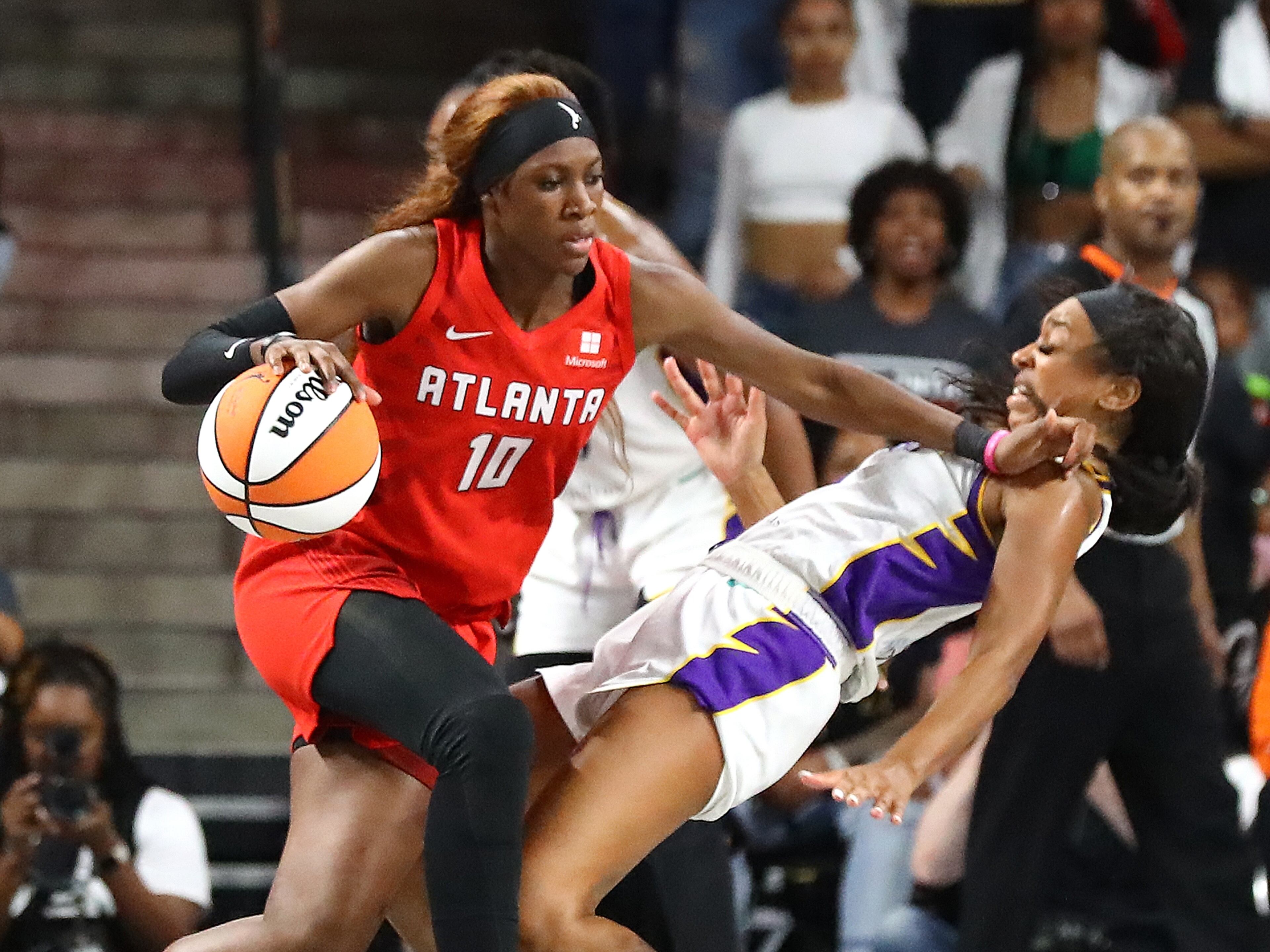Atlanta Dream guard Rhyne Howard, the no. 1 overall pick in the draft, knocks Los Angeles Sparks defender Lexie Brown to the hardwood for an offensive foul during the final minute of a 77-75 victory in the home opener of a WNBA basketball game on Wednesday, May 11, 2022, in College Park. “Curtis Compton / Curtis.Compton@ajc.com”