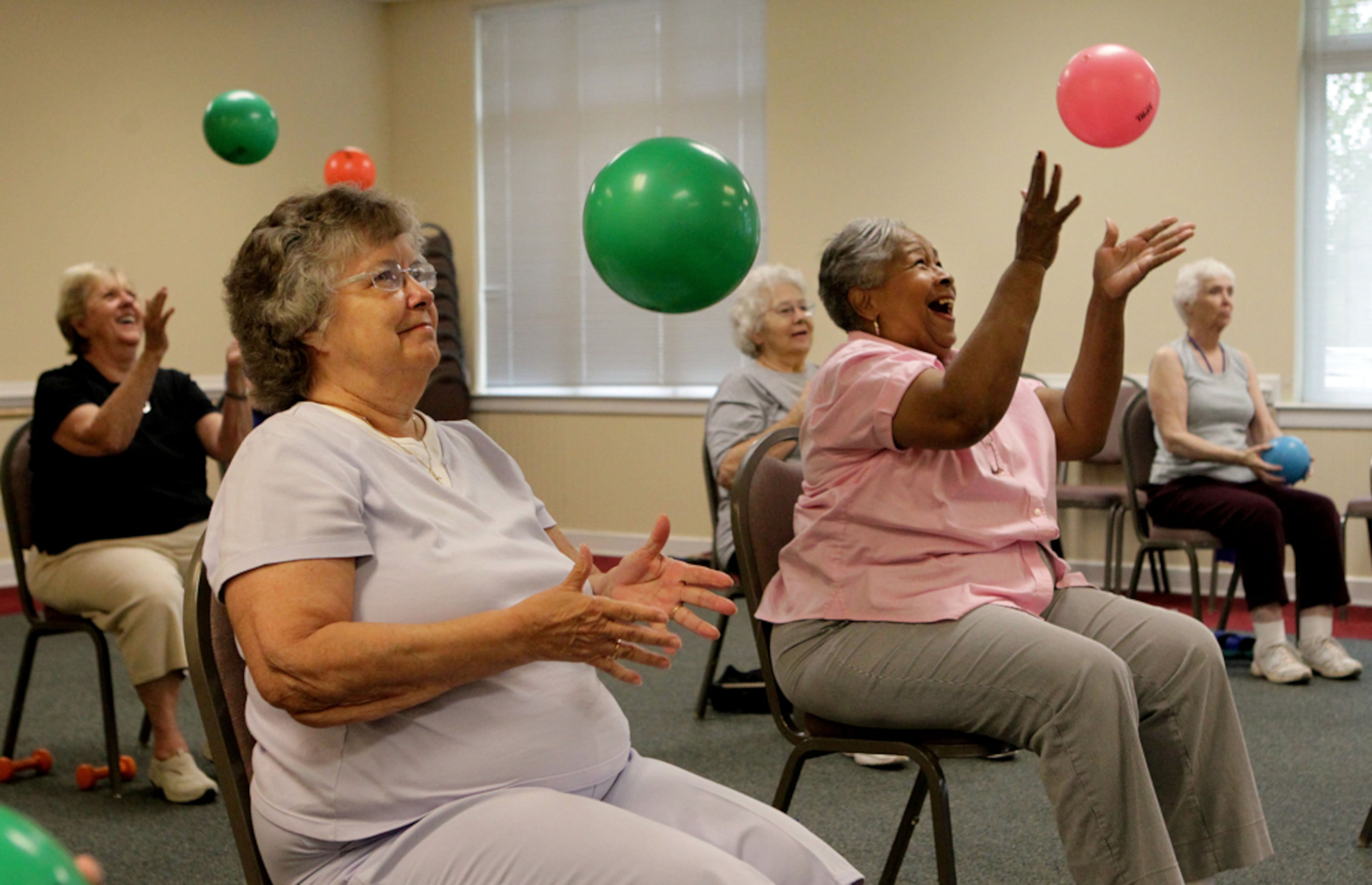 Participants toss a ball and clap during a beginners arthritis class at the Roswell Adult Recreation Center. (Phil Skinner/AJC)