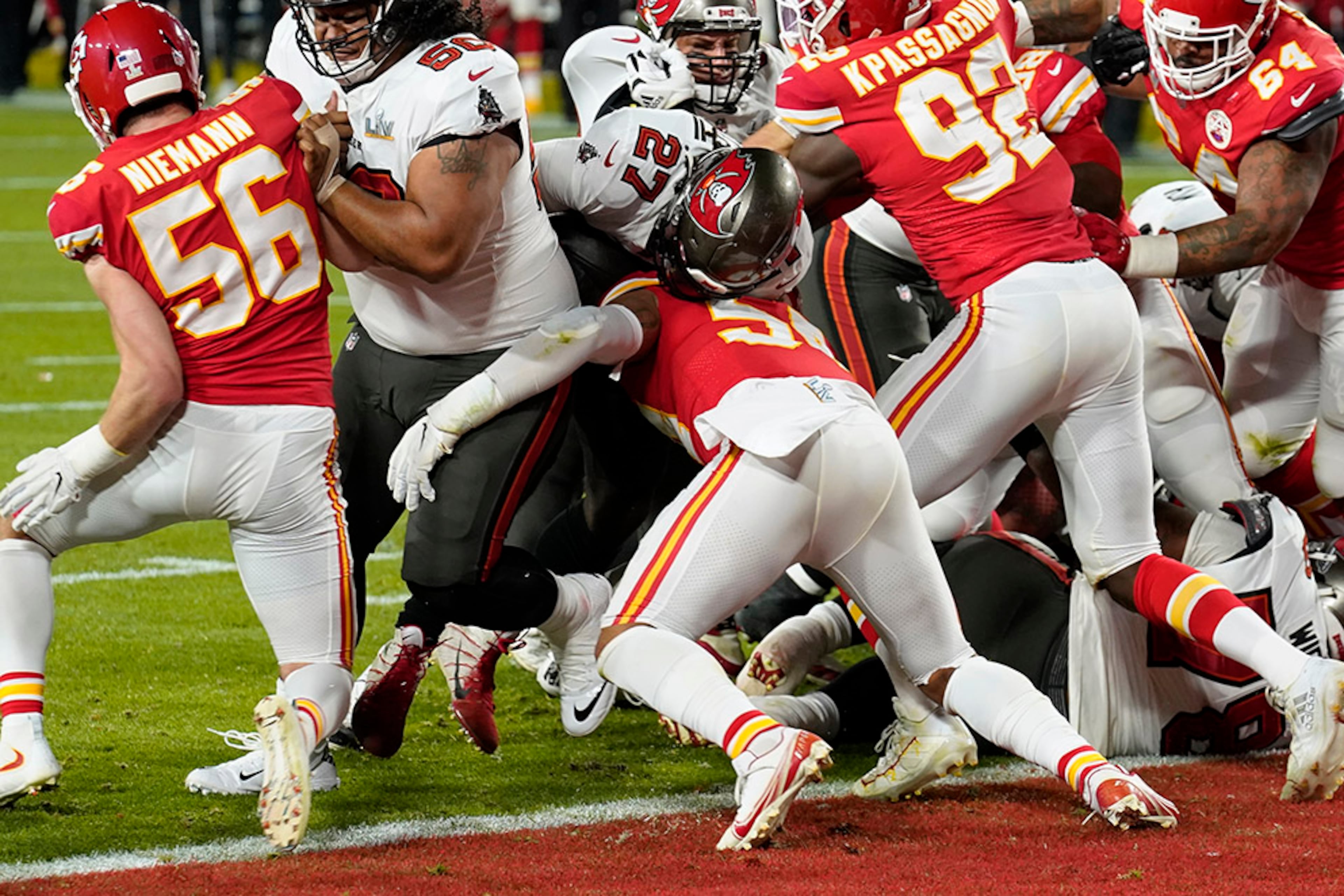 Tampa Bay Buccaneers running back Ronald Jones (27) is stopped short of the goal line on fourth down by Kansas City Chiefs' Ben Nieman (56), Tanoh Kpassagnon (92) and others during the first half of Super Bowl 55 Sunday, Feb. 7, 2021, in Tampa, Fla. (Chris O'Meara/AP)