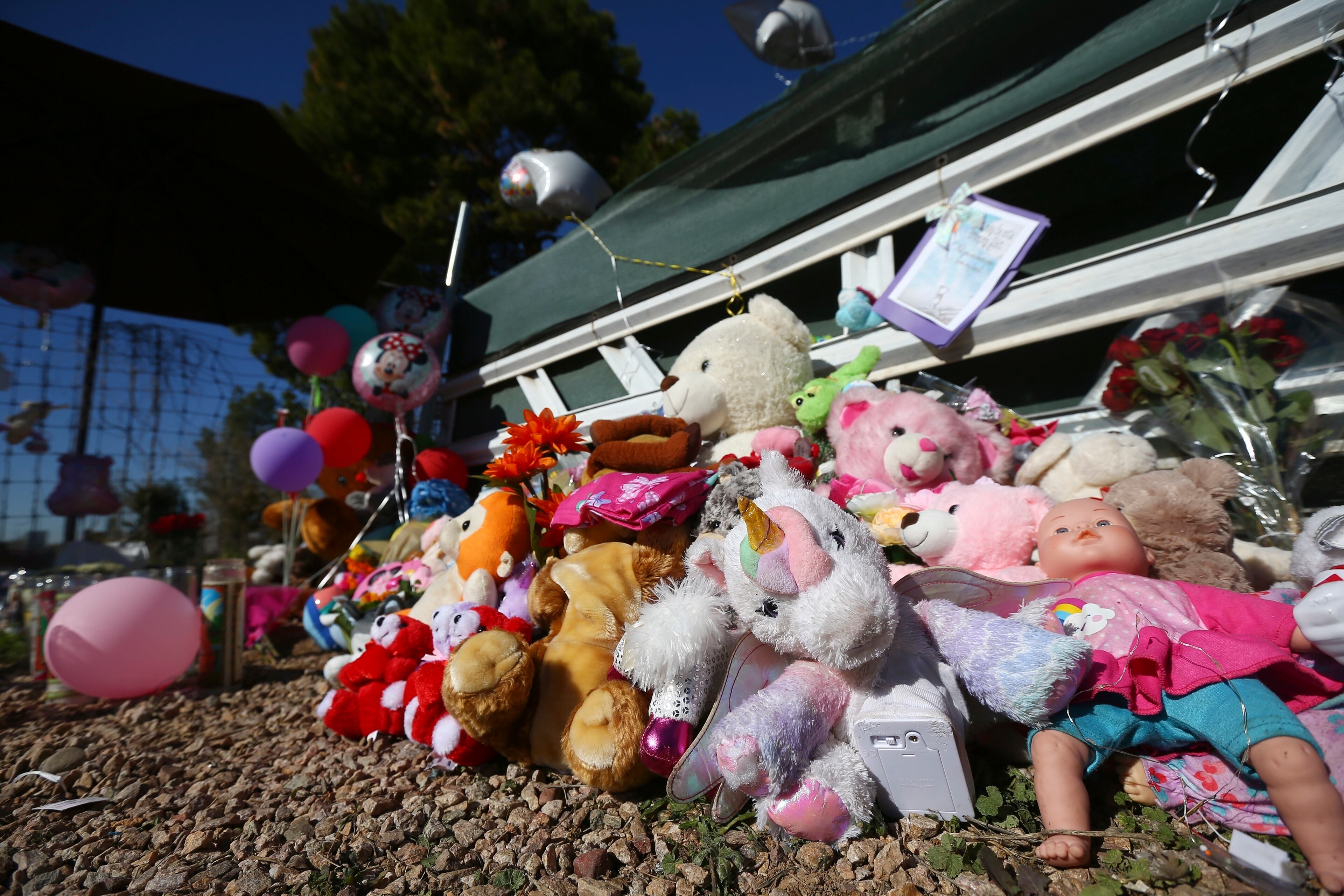 A makeshift memorial grows in front of the home where Rachel Henry was charged with killing her three children. The children were found dead inside the family home in Phoenix.