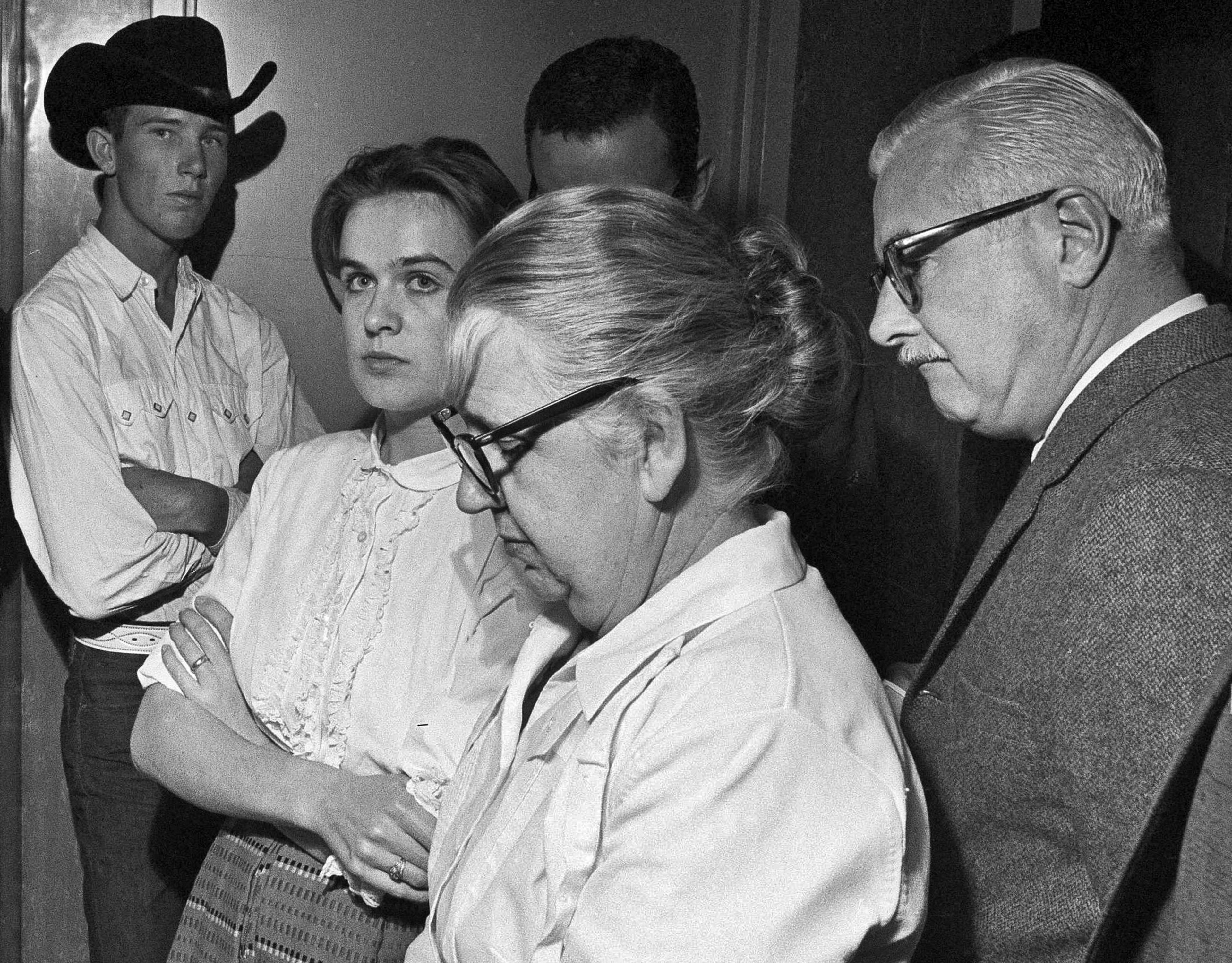 ADVANCE FOR USE SUNDAY, AUG. 18, 2013 AND THEREAFTER - FILE - In this Nov. 22, 1963 file photo, Marina Oswald, second left, stands with her mother-in-law, Marguerite Claverie Oswald, in the police station in Dallas where her husband, Lee Harvey Oswald is being held, accused in the assassination of President John F. Kennedy. (AP Photo)