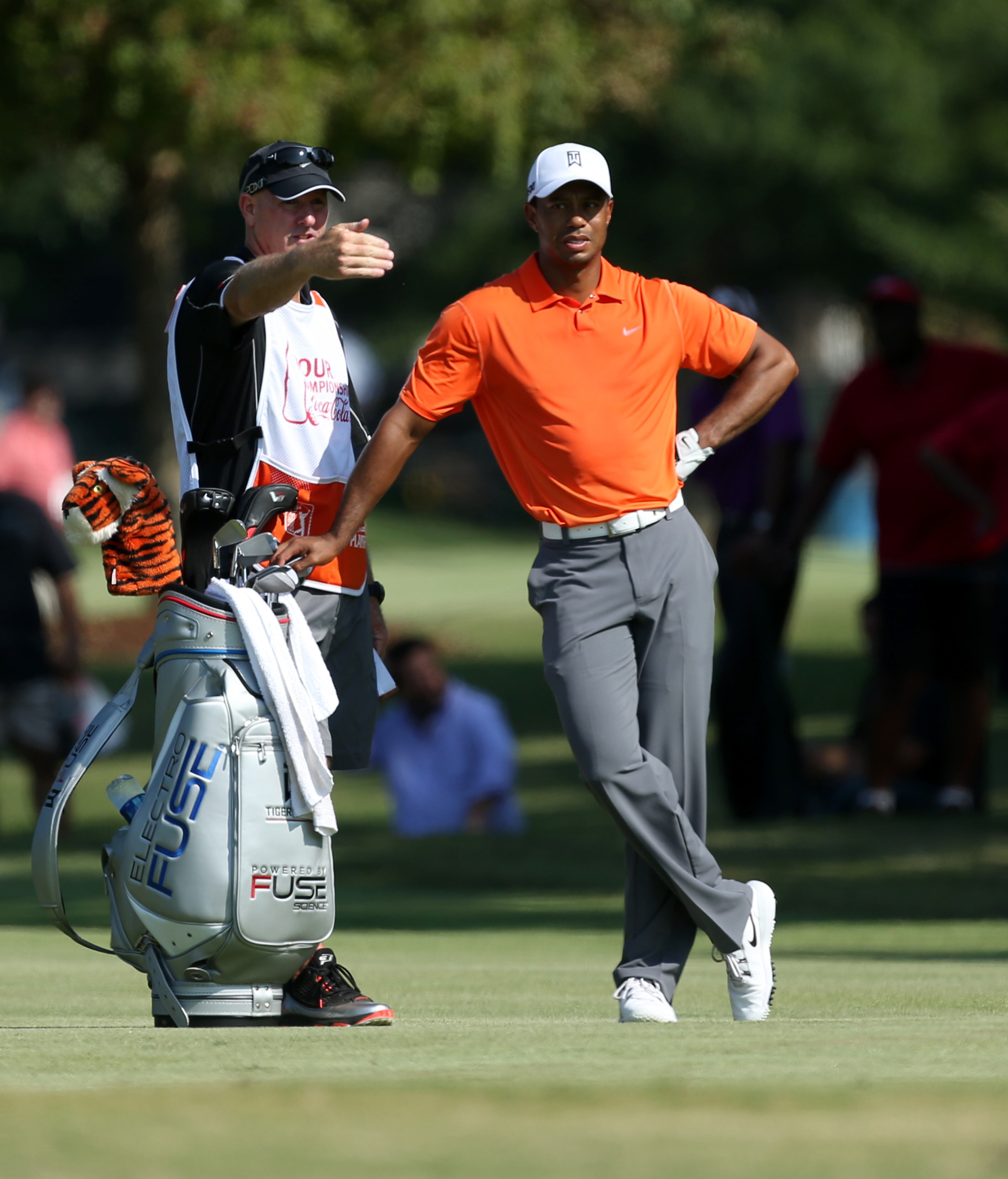 Tiger Woods, right, talks with his caddie Joe LaCava, left, before his shot on the No. 12 fairway during round one of the 2013 Tour Championship at East Lake Golf Club Thursday morning in Atlanta, Ga., September 19, 2013. Woods finished in 29th place with a round of 3 over par.